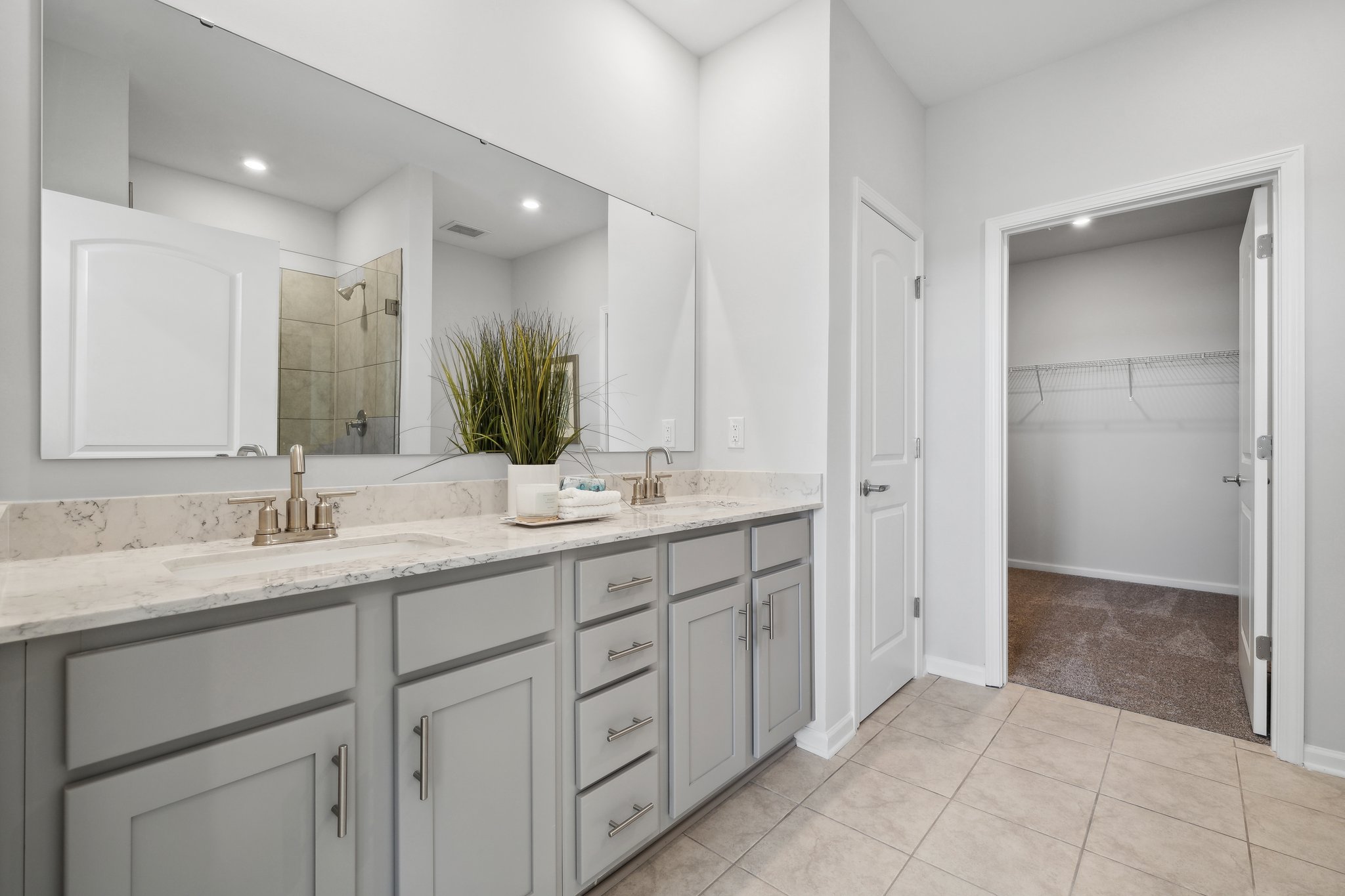 A bathroom with white cabinets.