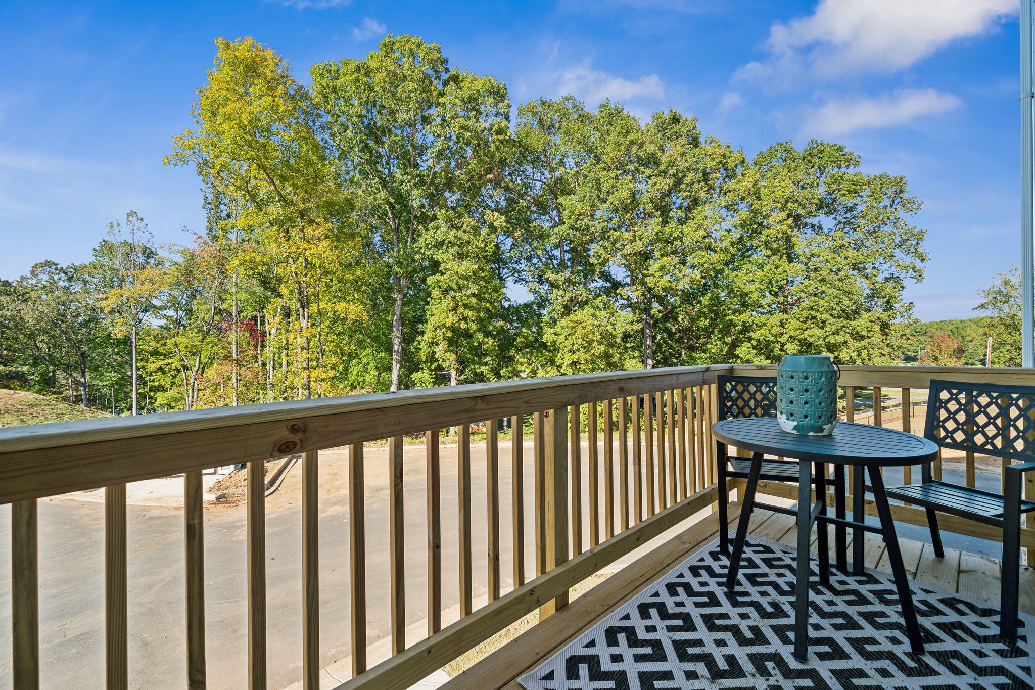 A table and chairs on a deck.