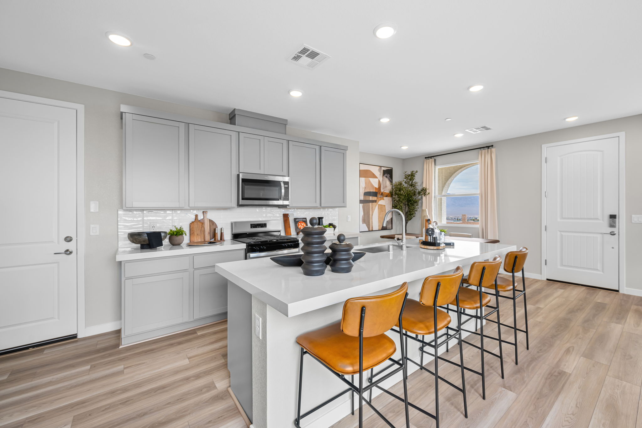 A kitchen with white cabinets.