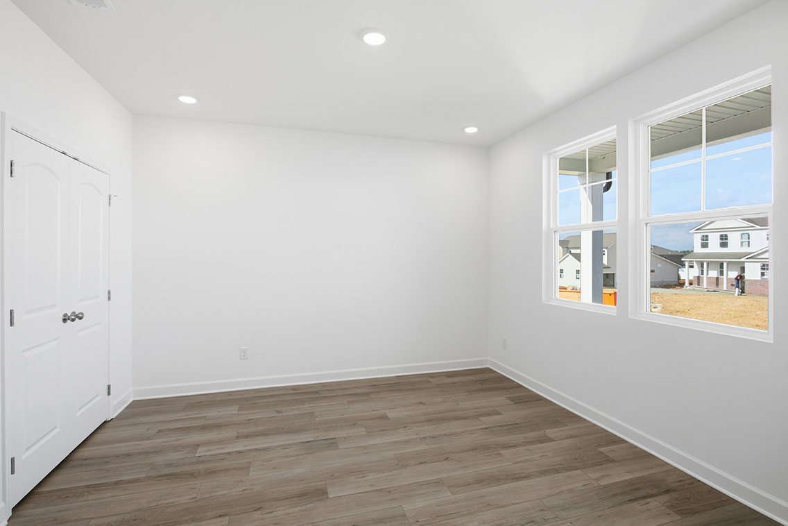 A room with white walls and a wood floor.