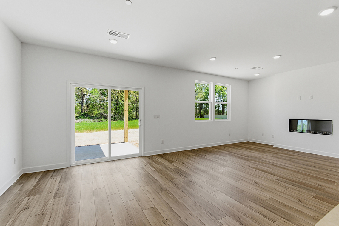 A room with a wood floor and a wood floor with a window.