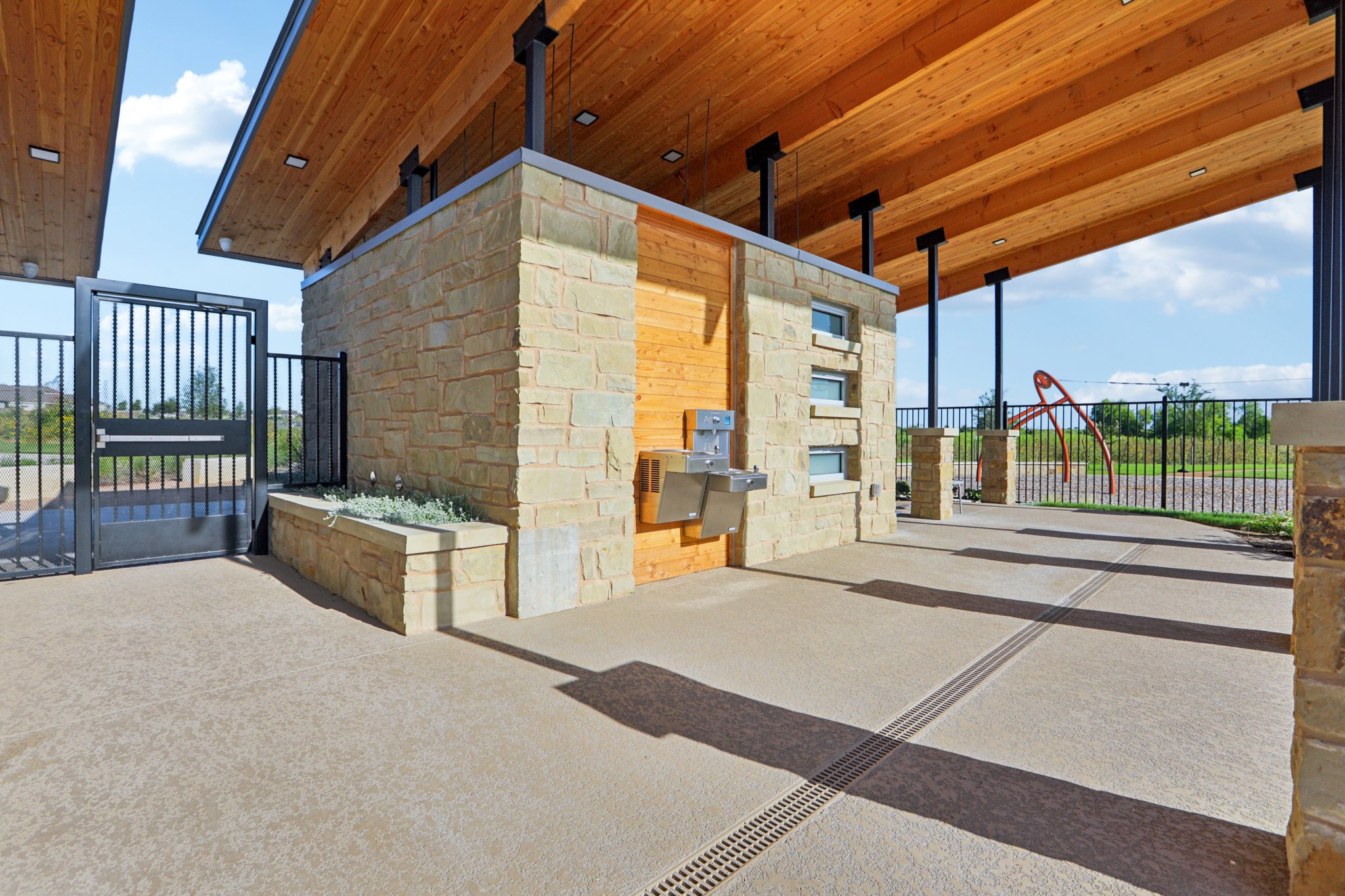 A building with a fence and a brick patio.