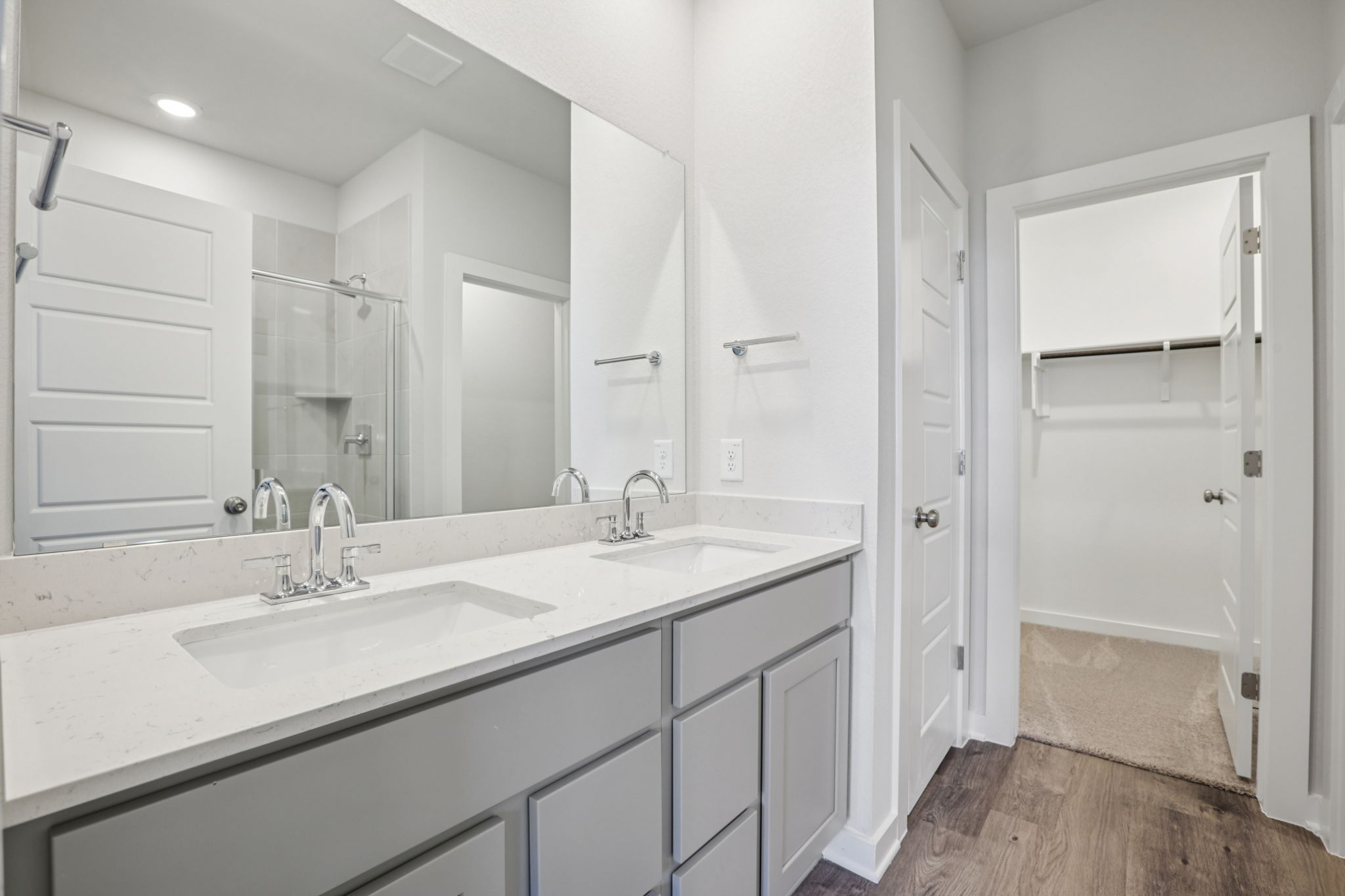 A bathroom with white cabinets.