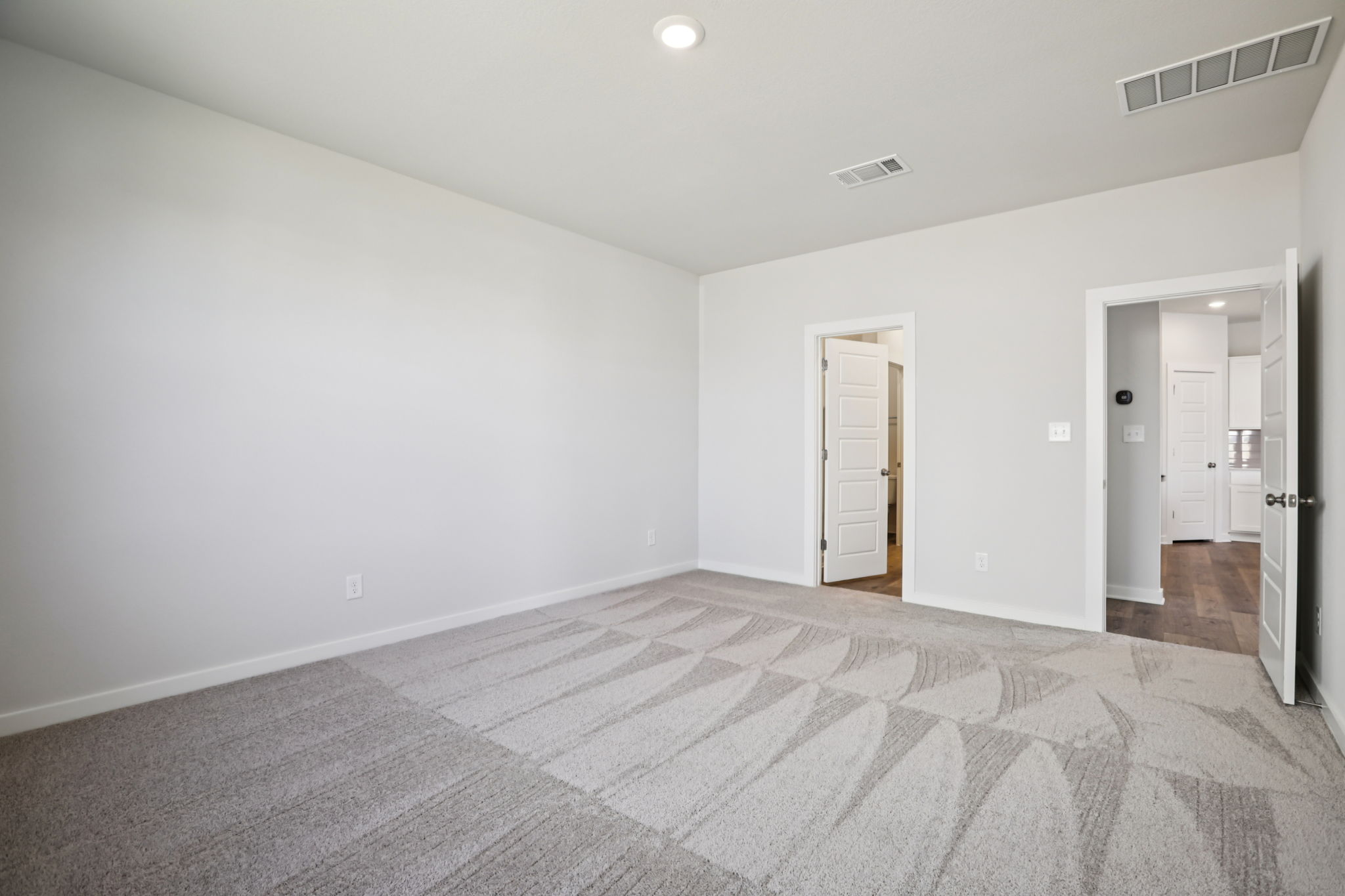 A room with a carpet and a rug.