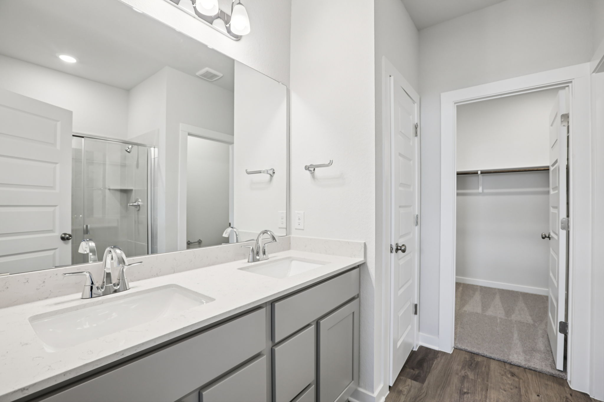 A bathroom with a large mirror.