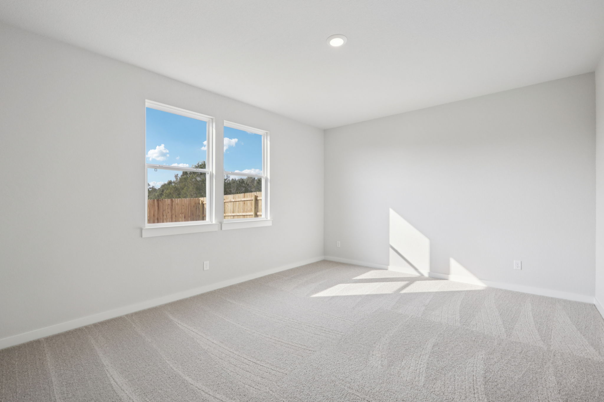 A room with a window and a staircase.