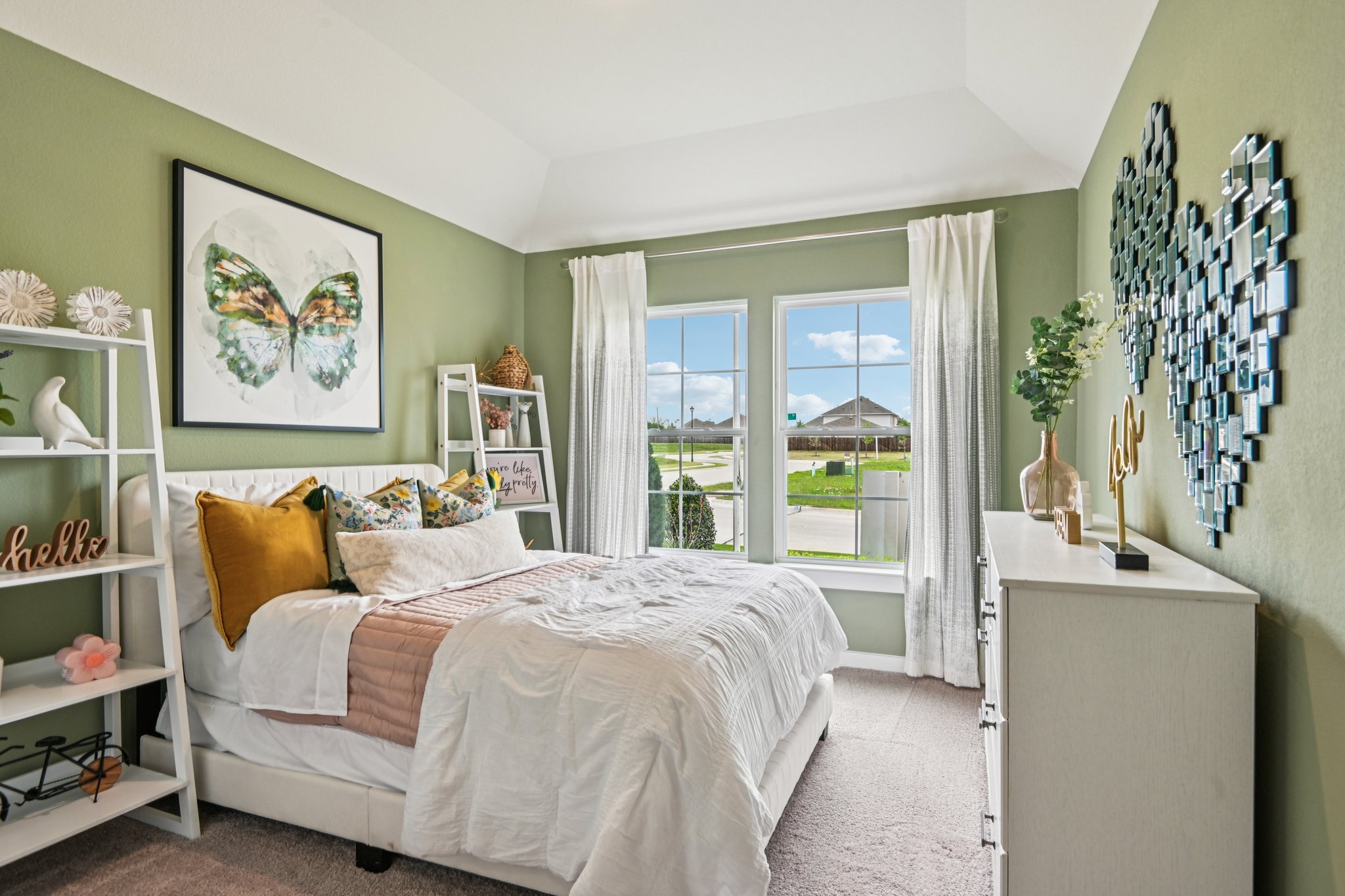 A bedroom with a large window.