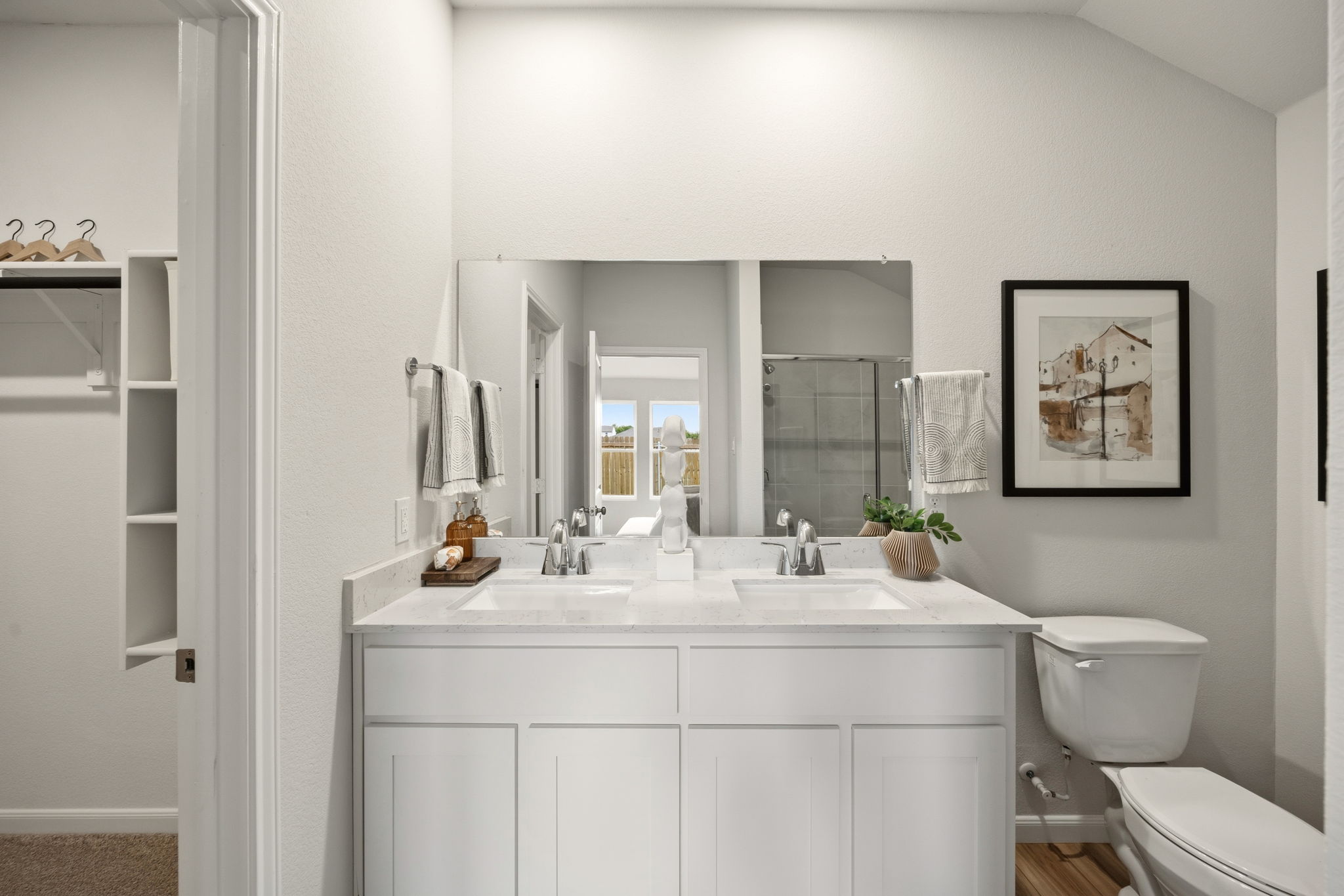 A bathroom with white cabinets.