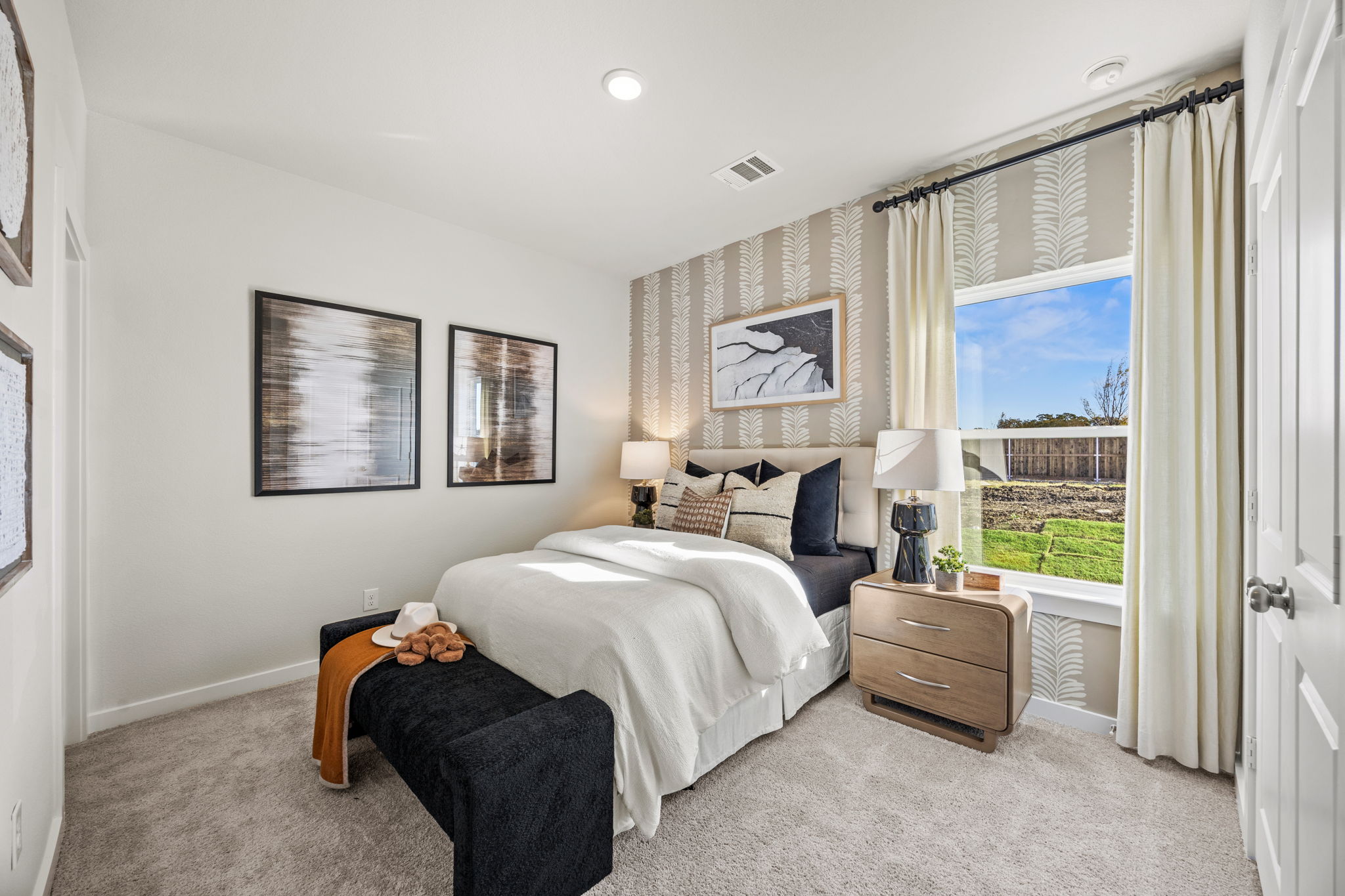 A bedroom with a large window.