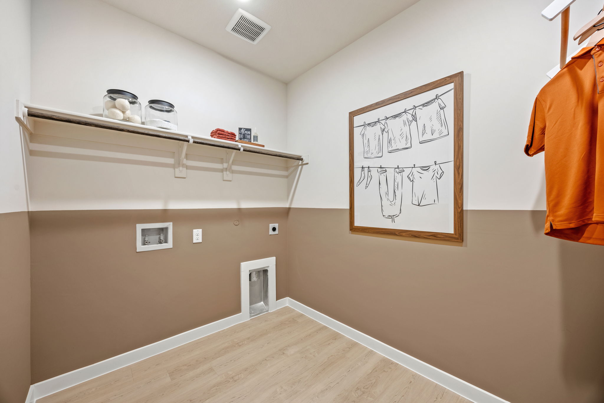 A room with a shelf and a wall with a sign on it.