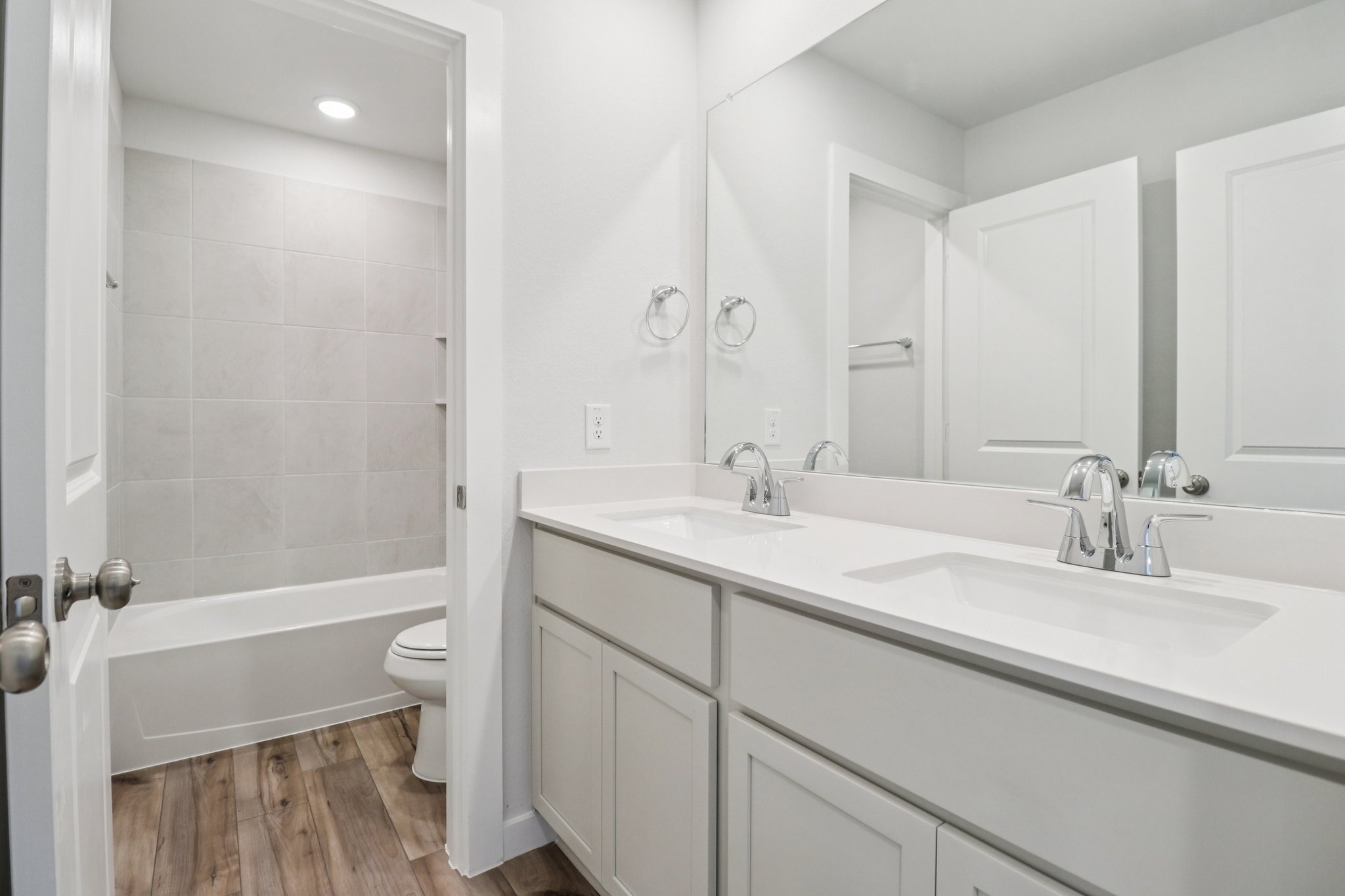 A bathroom with a tub sink and toilet.