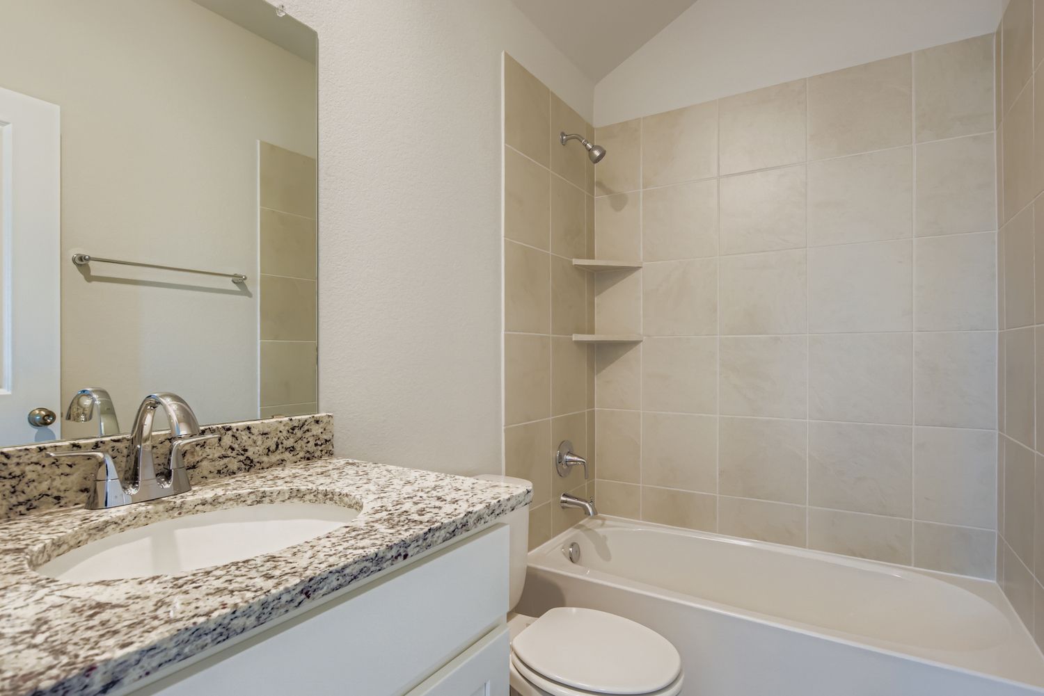 A bathroom with a tub sink and toilet.