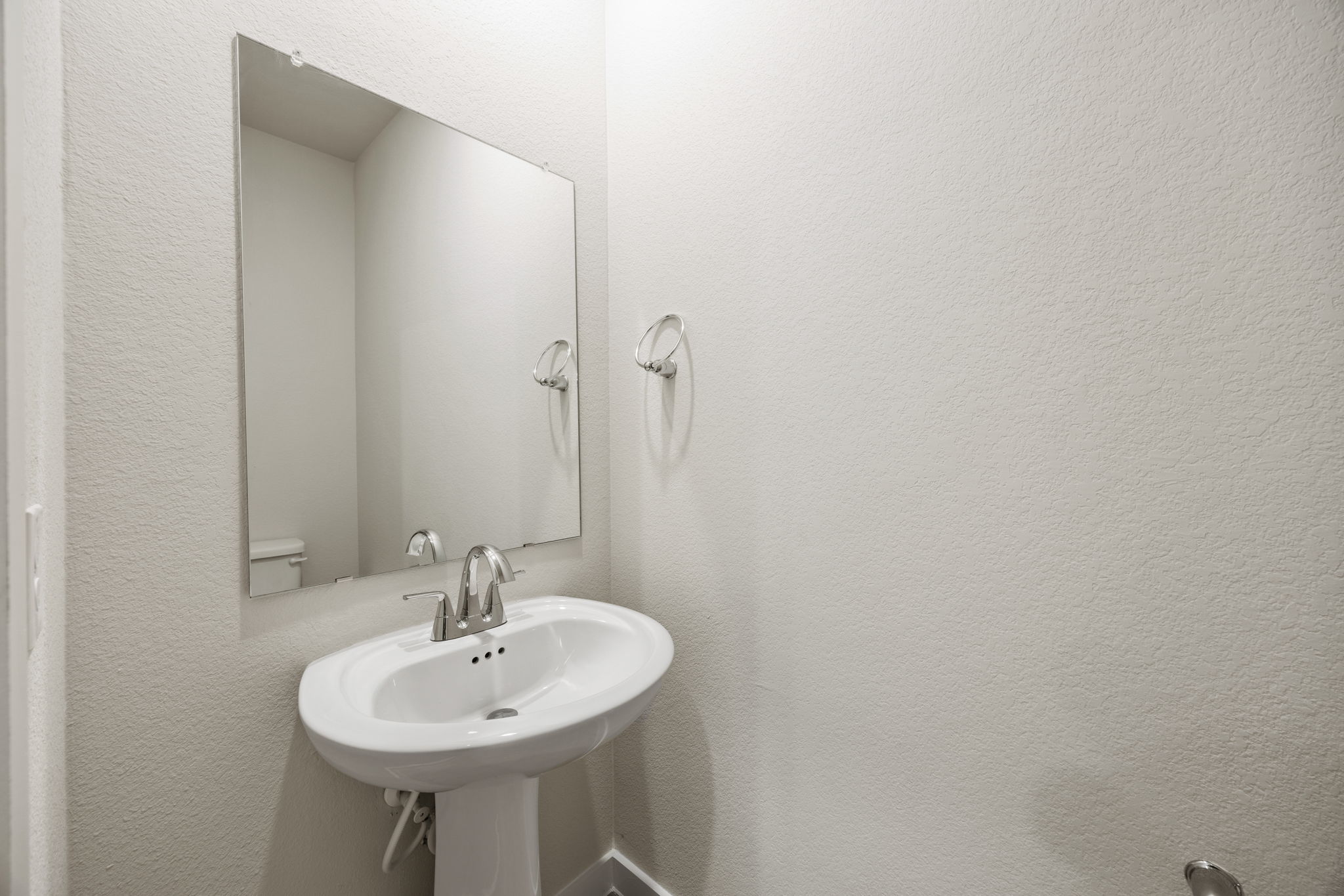 A bathroom with a mirror and sink.