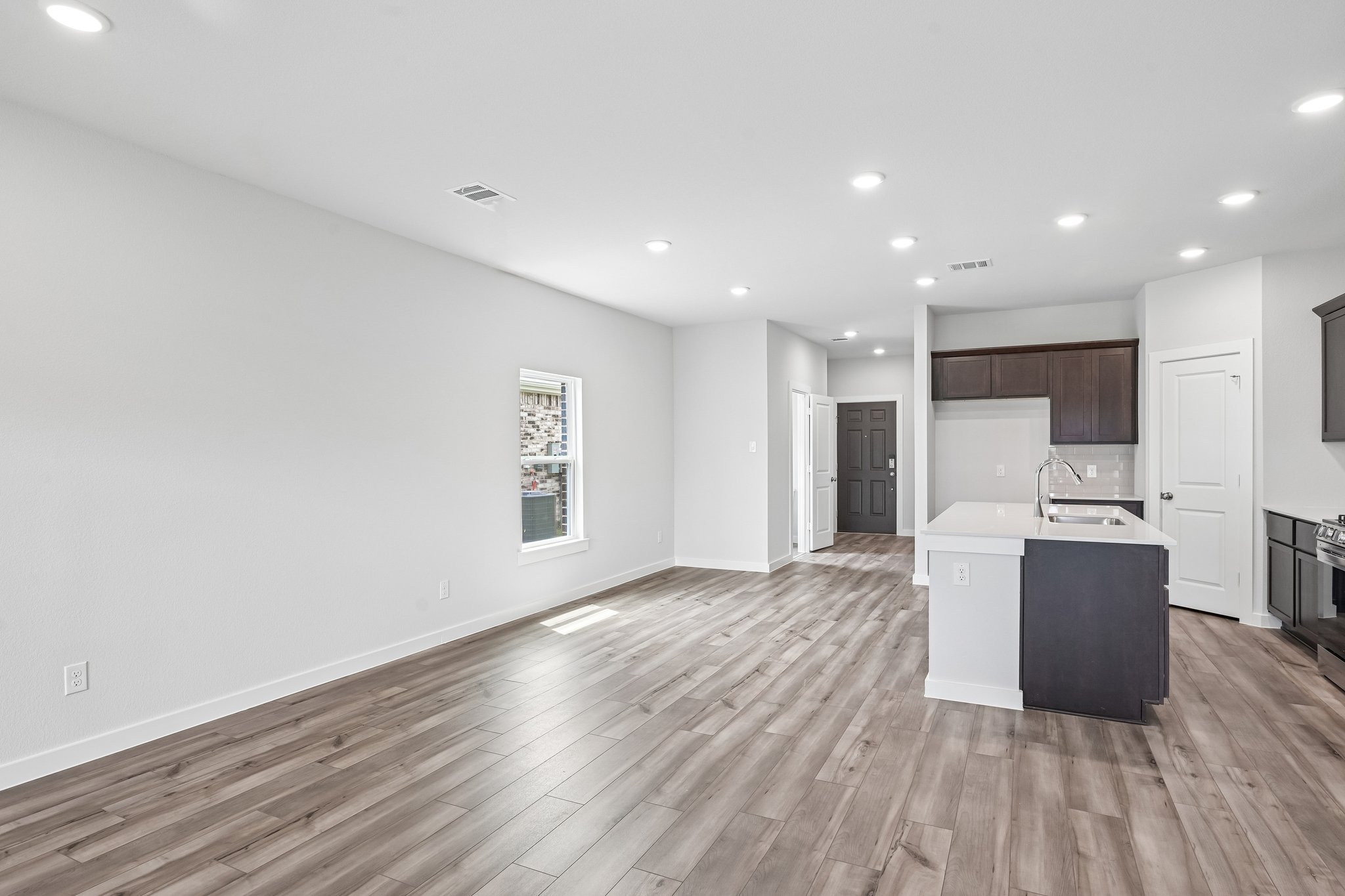 A kitchen with white cabinets.