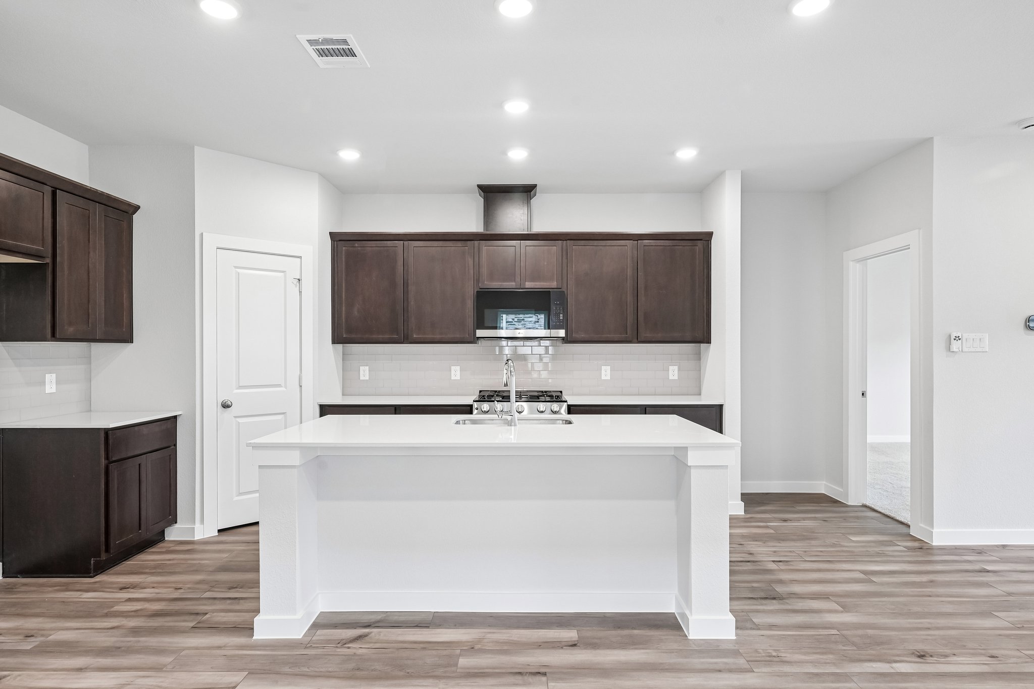 A kitchen with a tv and cabinets.