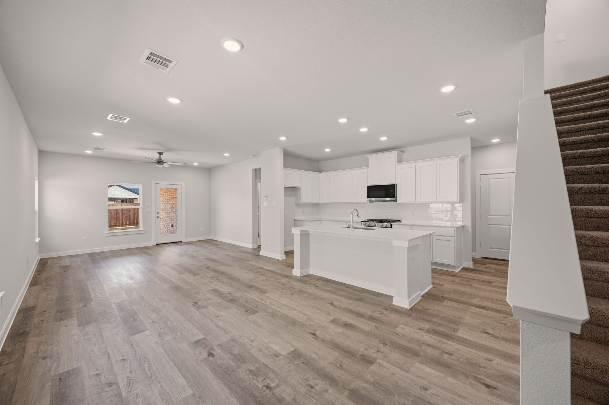 A large kitchen with white cabinets.