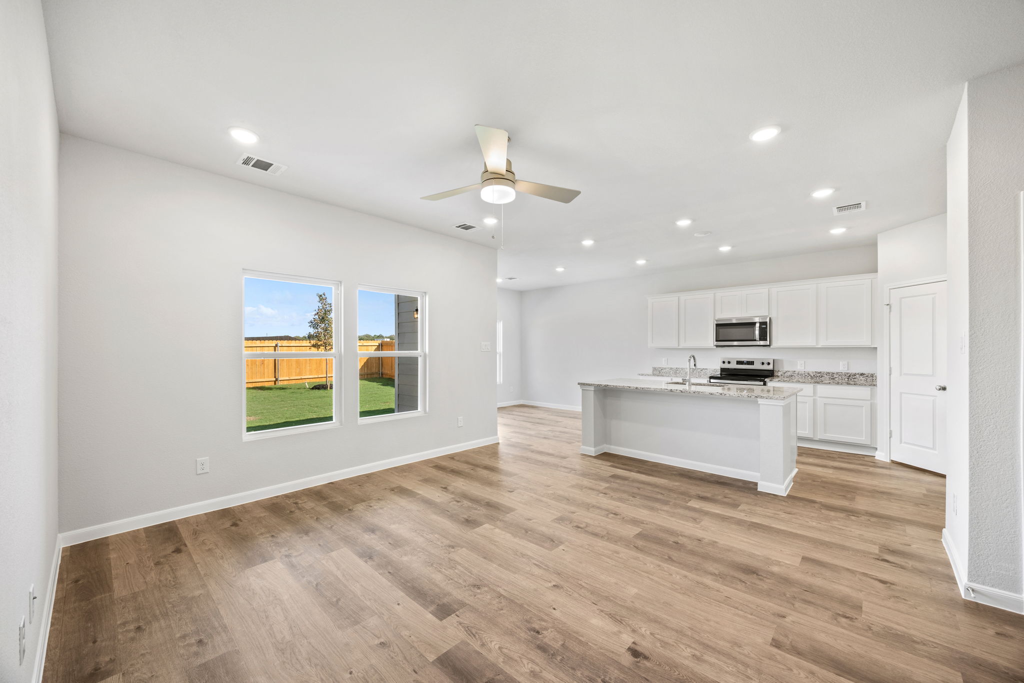 A kitchen with white cabinets.