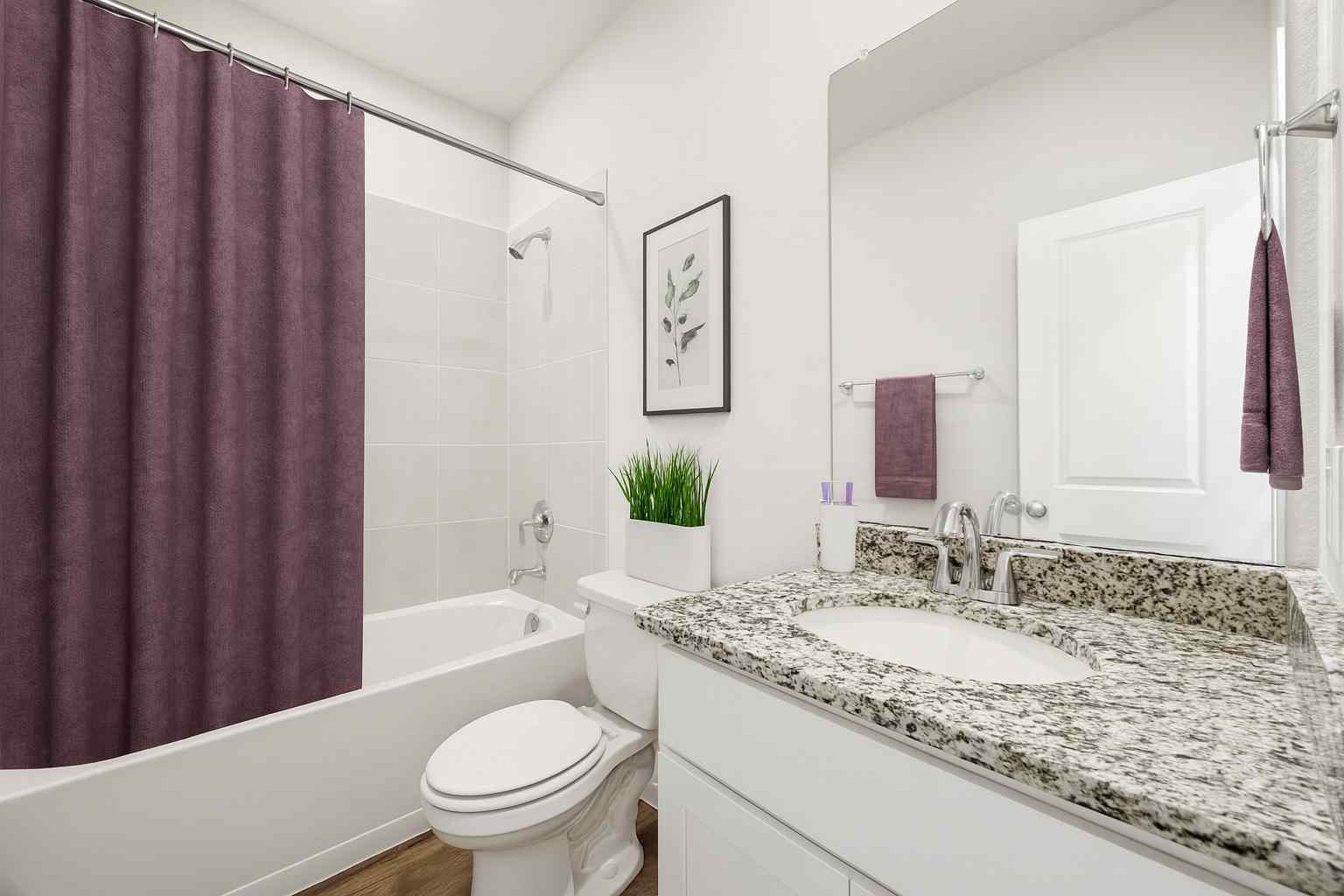 A bathroom with a marble countertop.