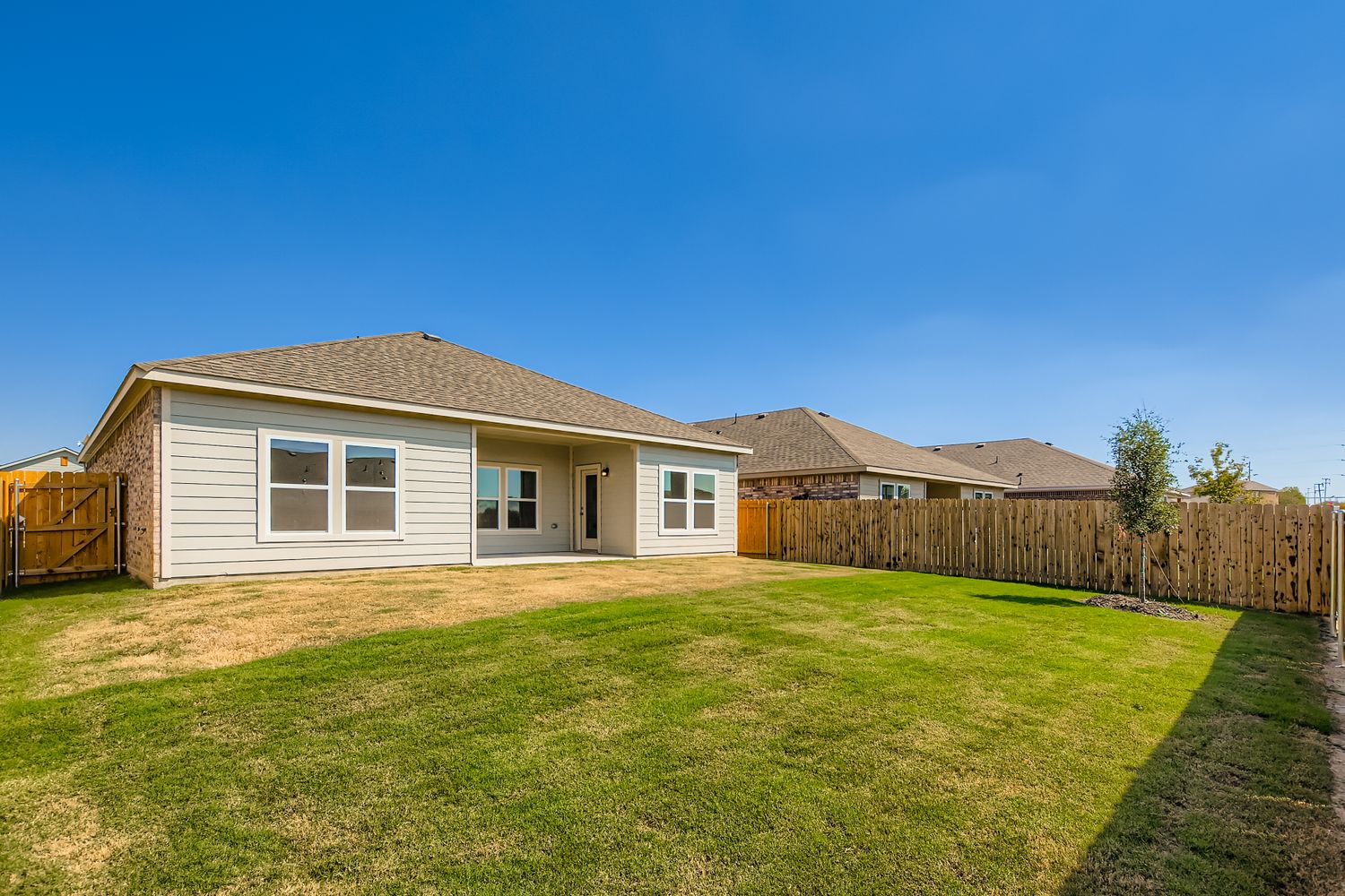 A house with a fence and grass.