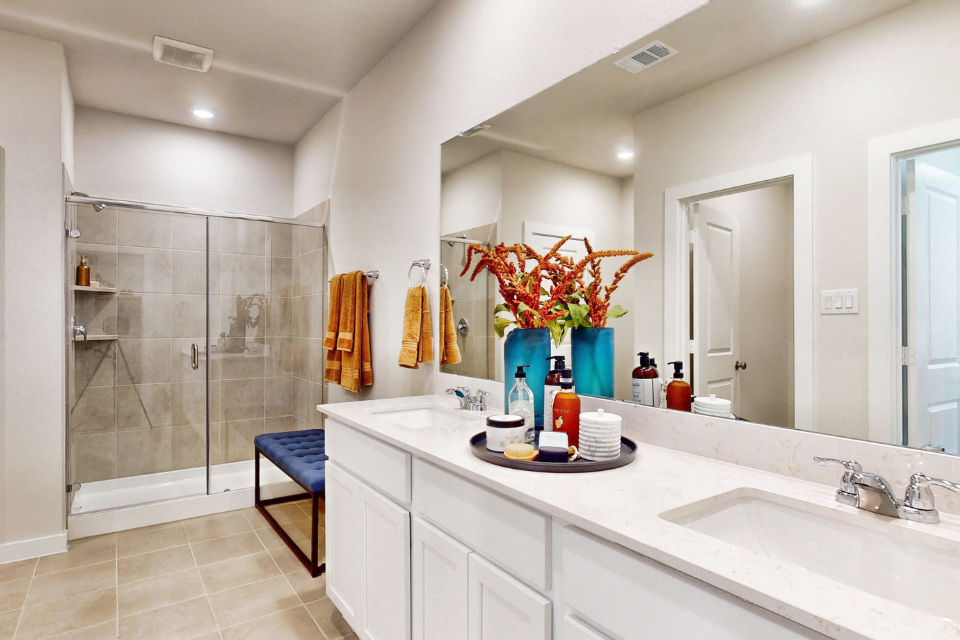 A bathroom with a sink and a shower.