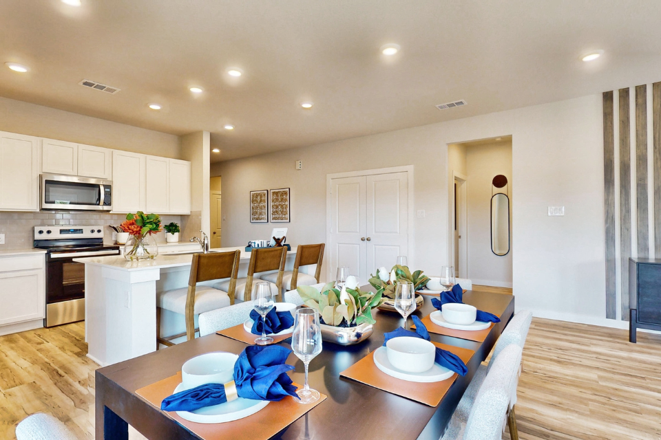 A kitchen with a dining table.