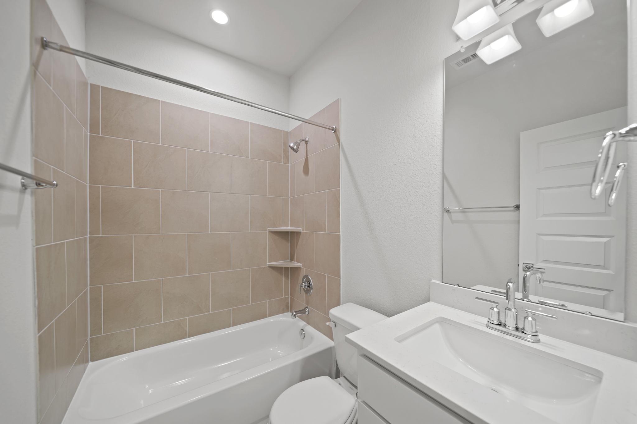A bathroom with a tub sink and toilet.