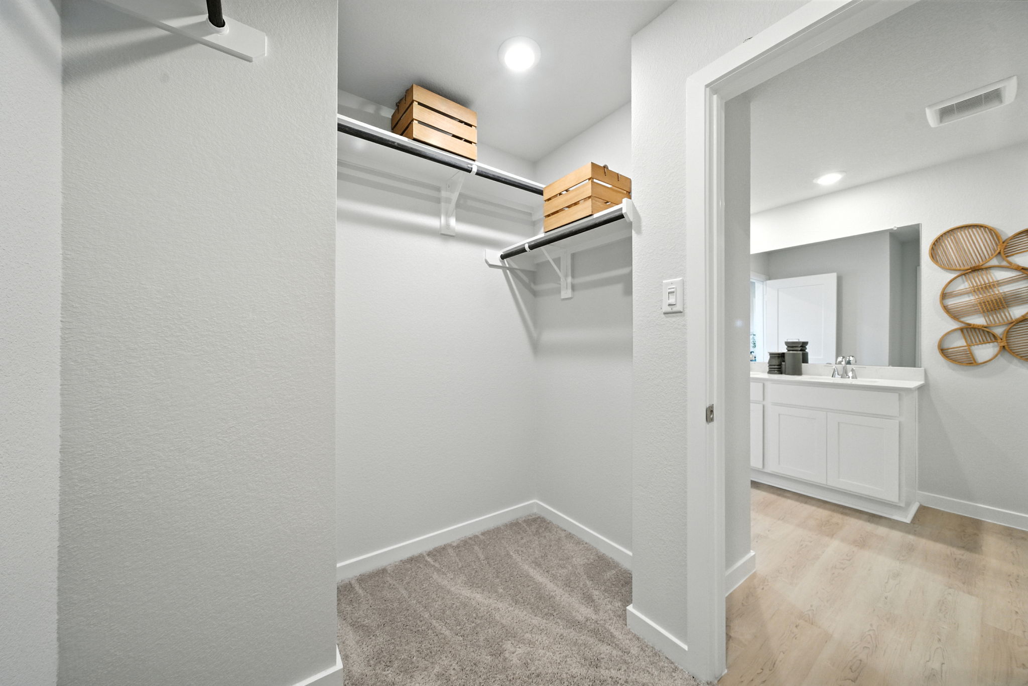 A bathroom with a mirror and a sink.
