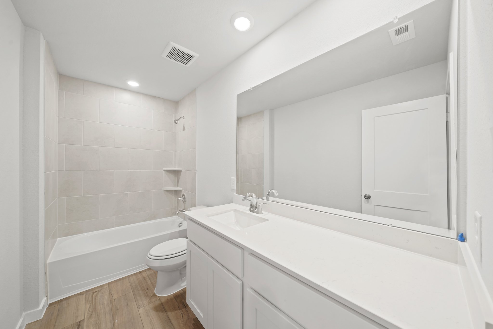 A bathroom with a tub sink and toilet.