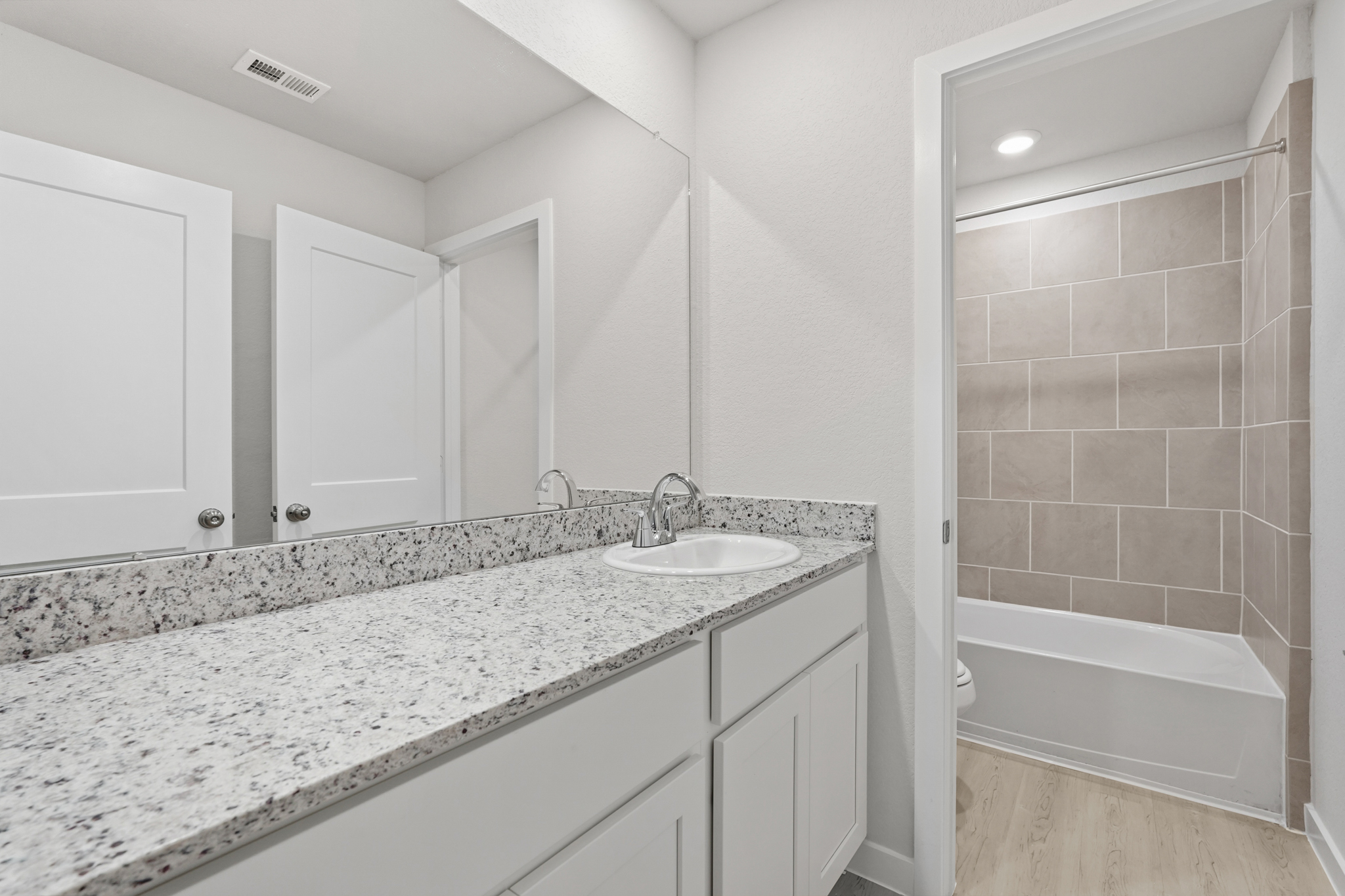 A bathroom with a marble countertop.