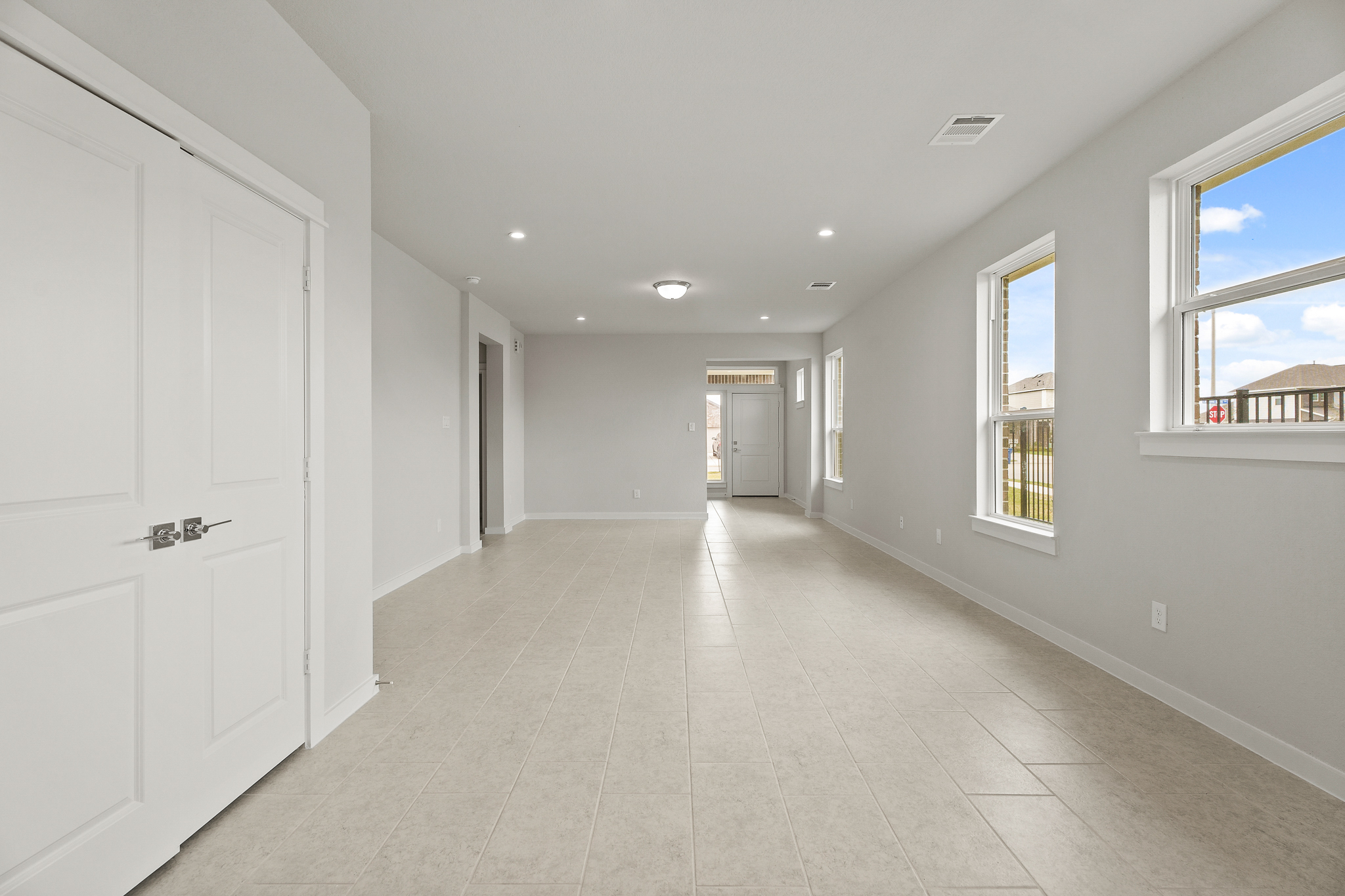 A long hallway with white doors.