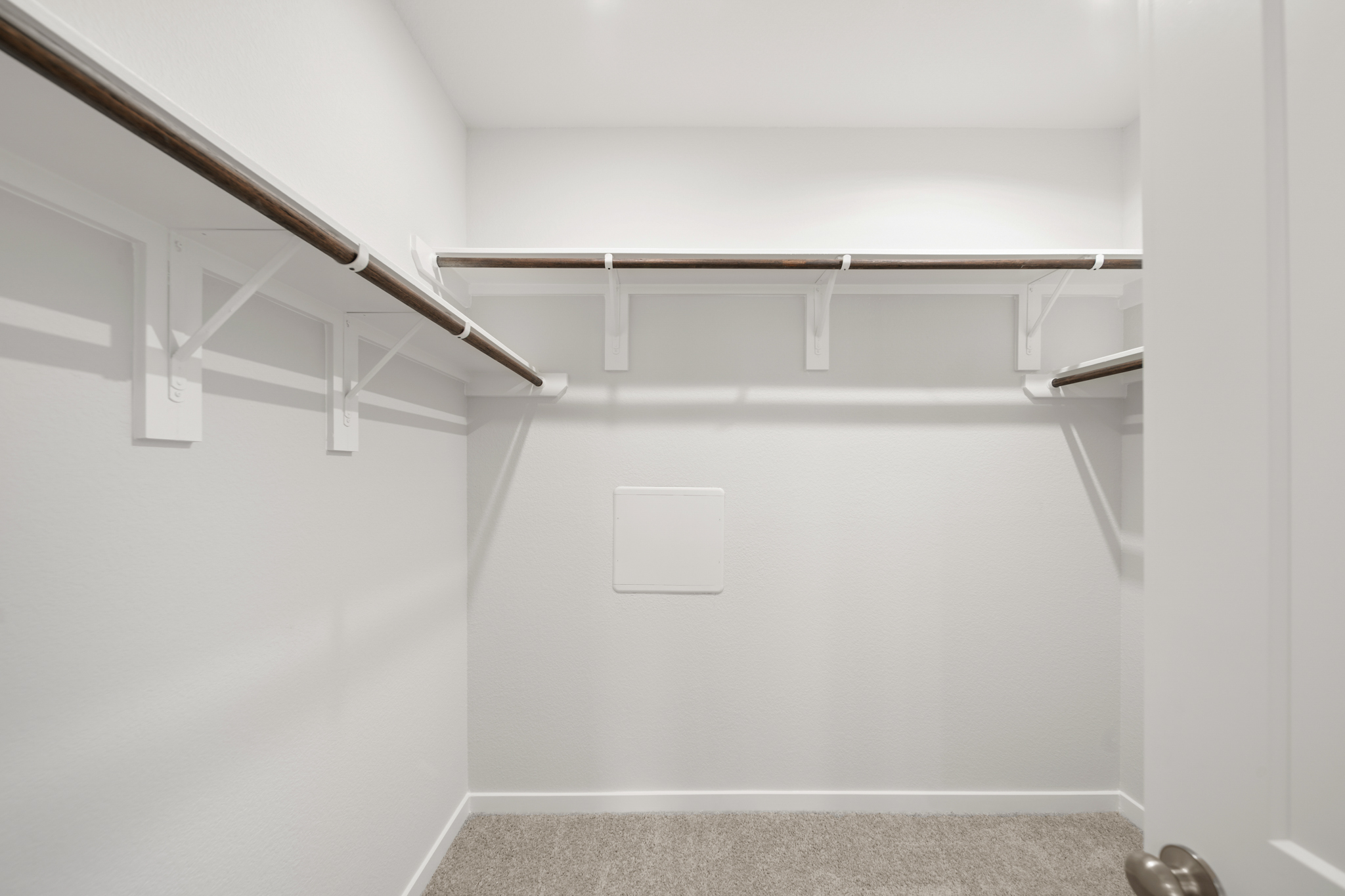 A white wall with a metal railing.