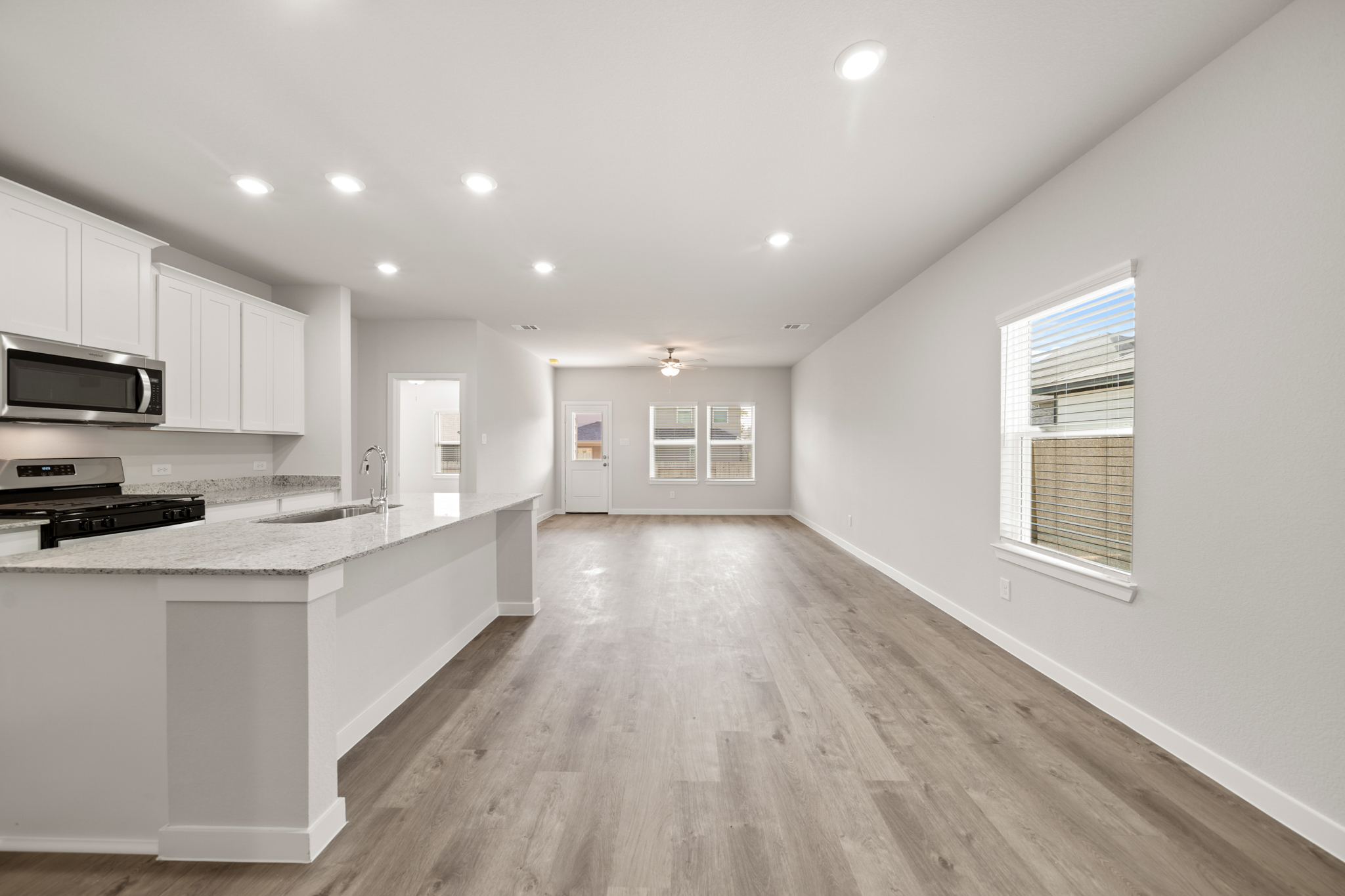 A kitchen with white cabinets.