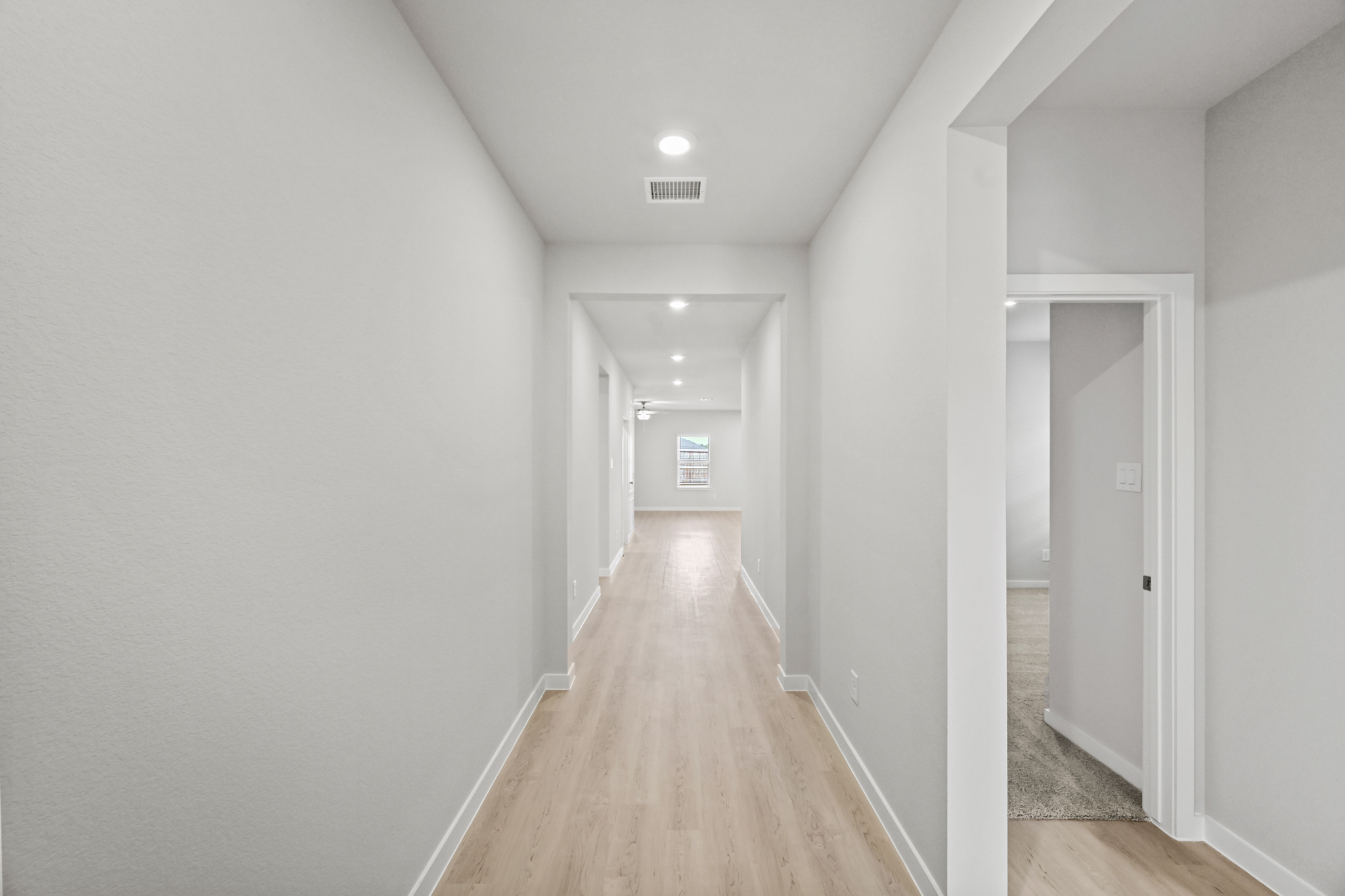 A hallway with white walls.