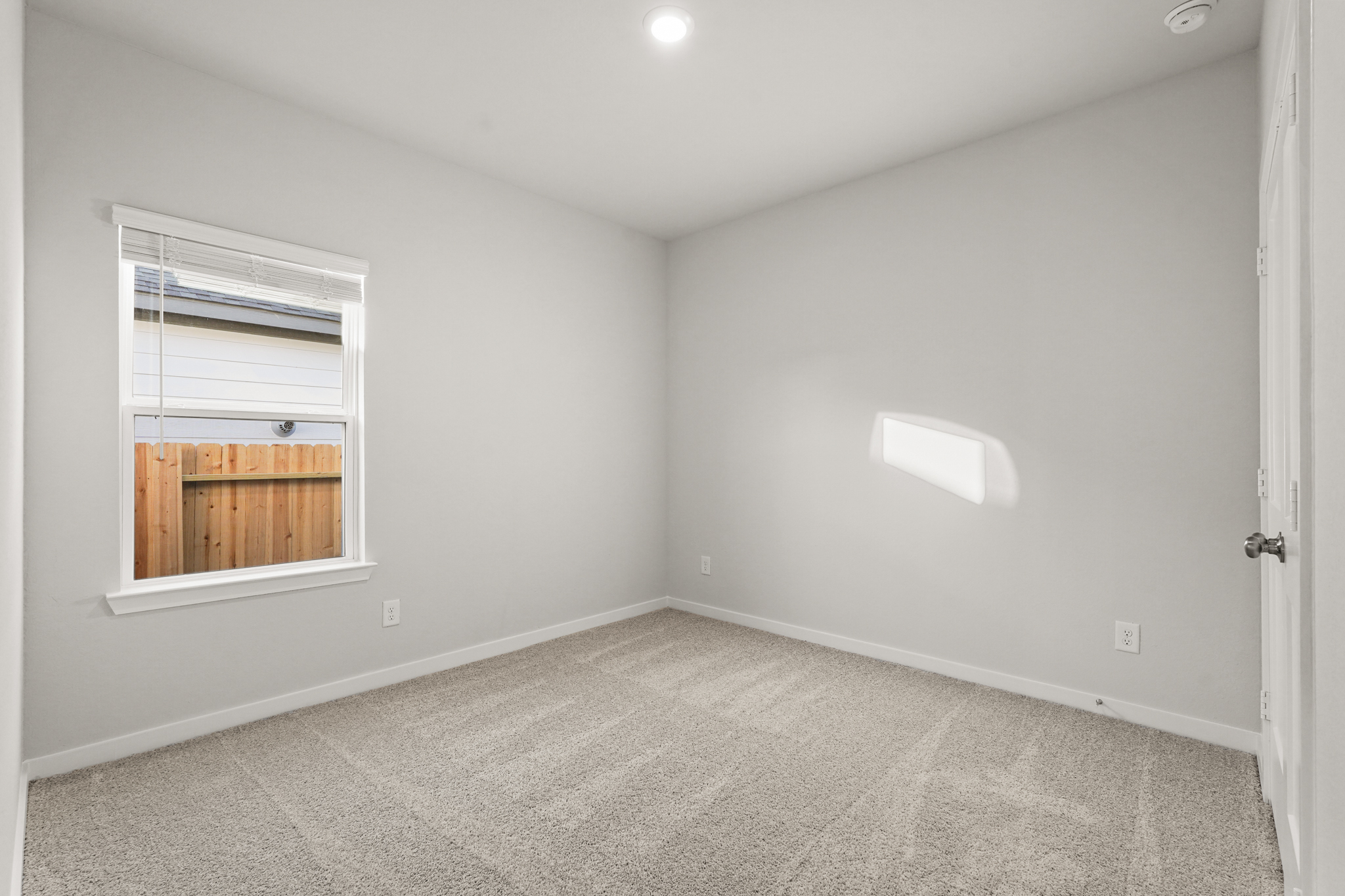 A room with a window and a door.