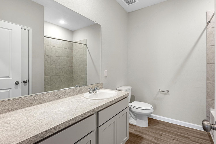 A bathroom with a marble countertop.
