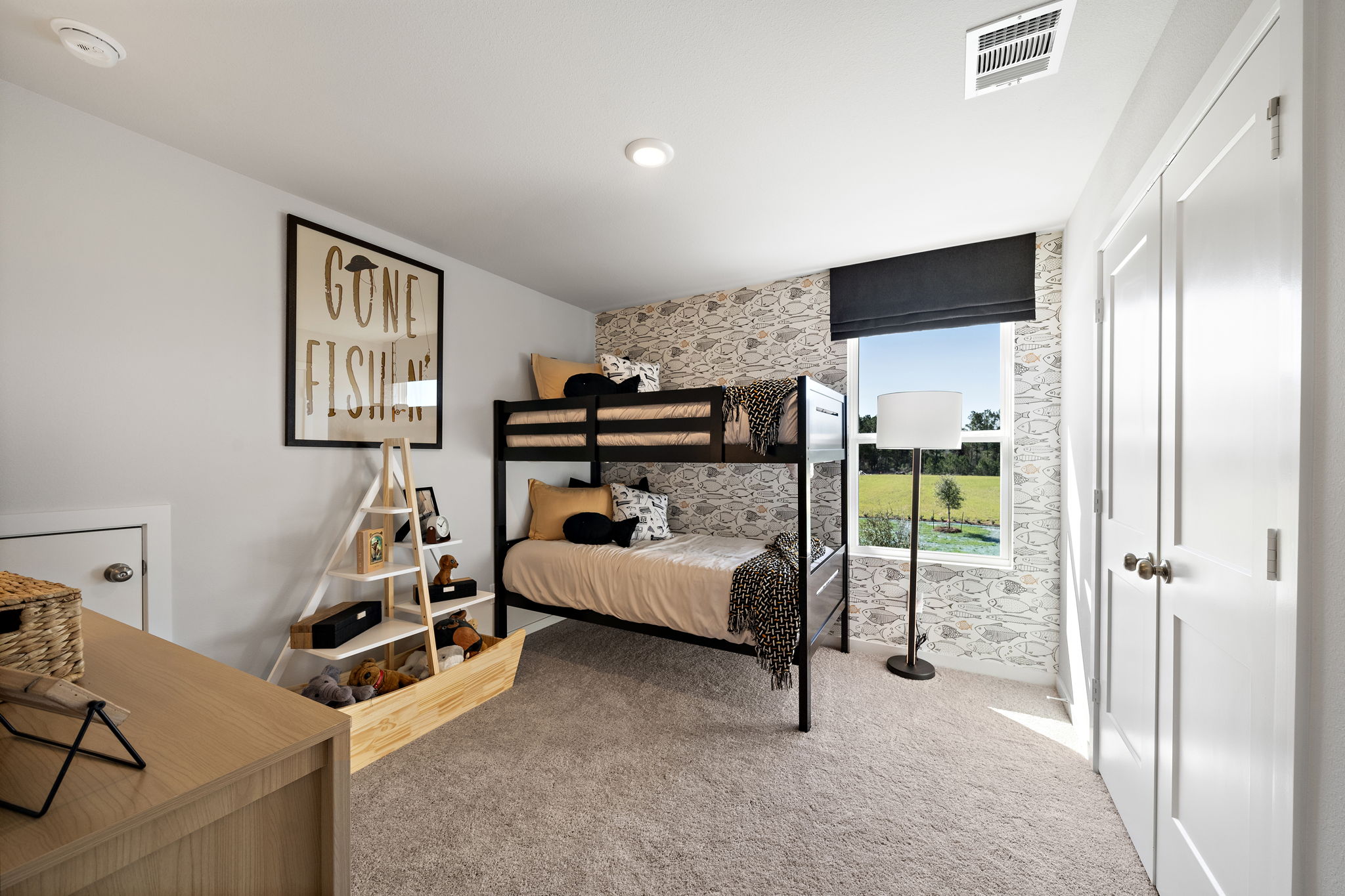 A bedroom with a bed and a lamp.