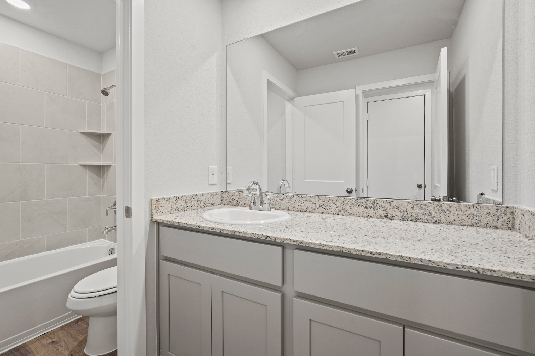 A bathroom with a marble countertop.