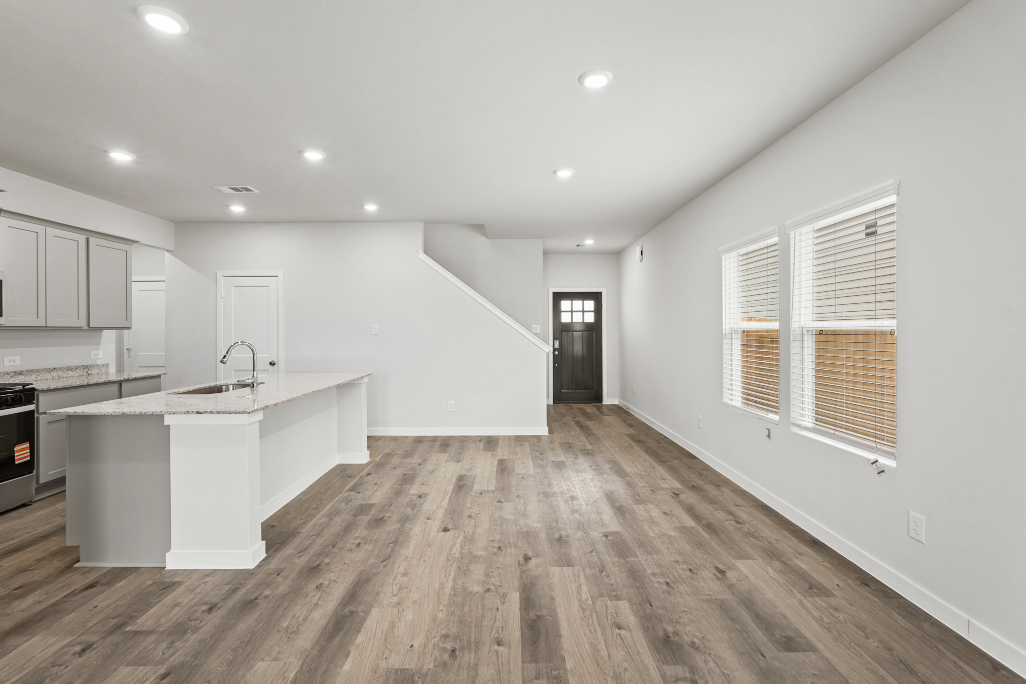 A kitchen with white cabinets.