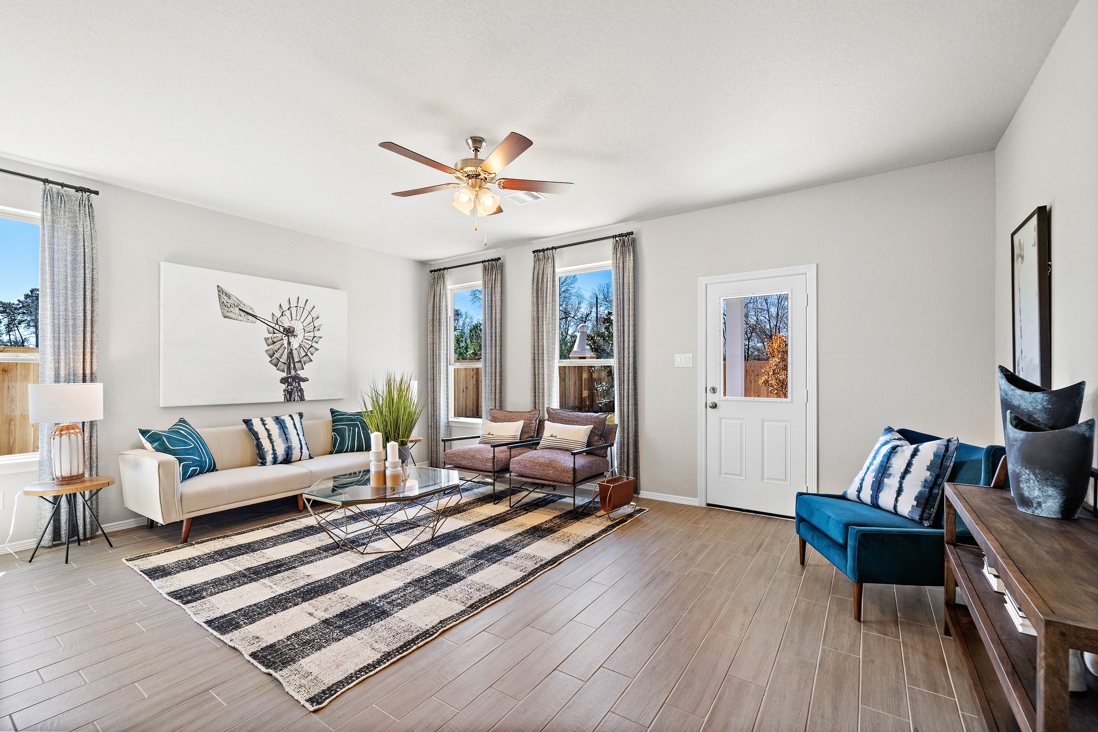 A living room with a rug and a wood floor.