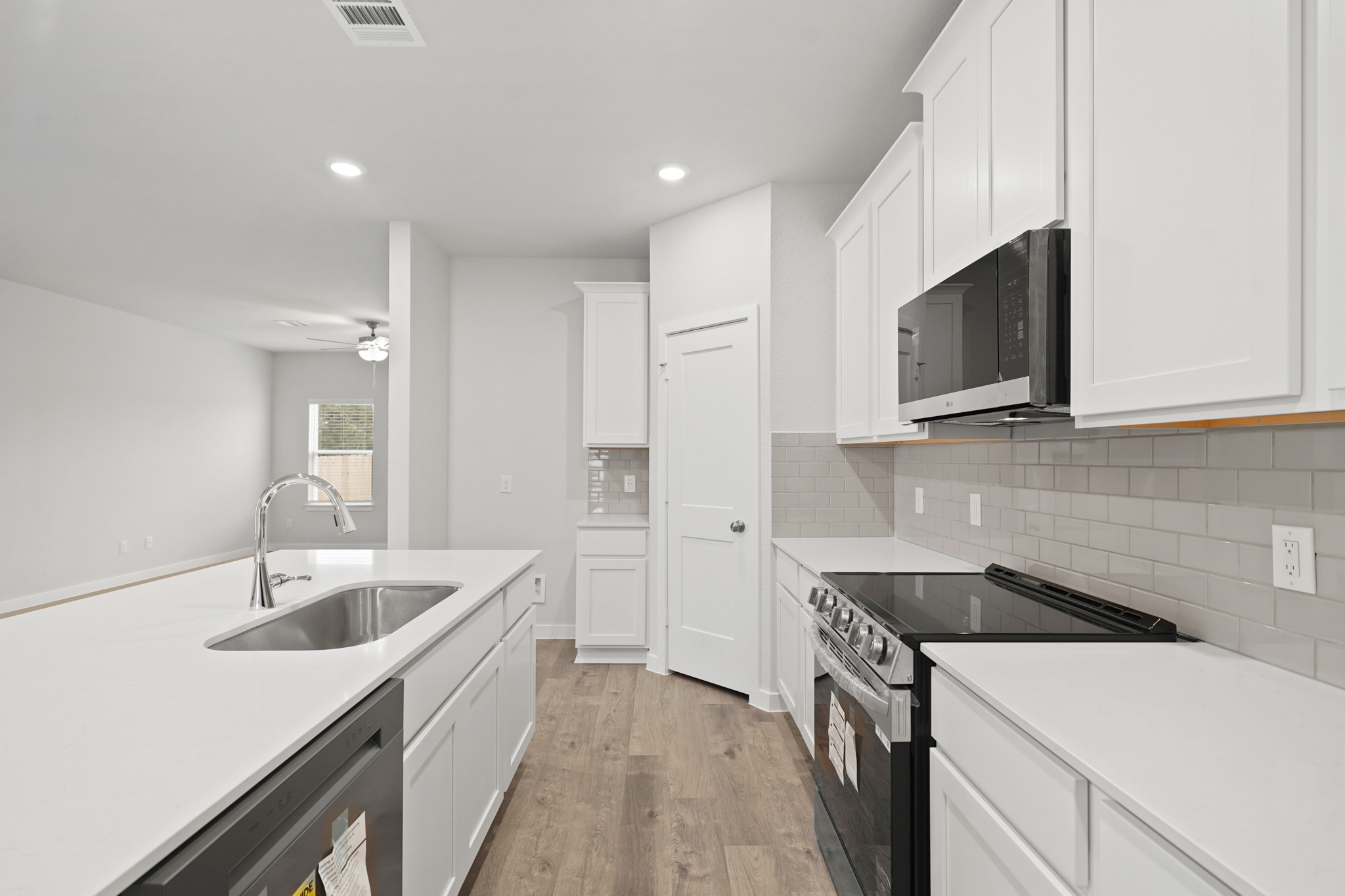 A kitchen with white cabinets.