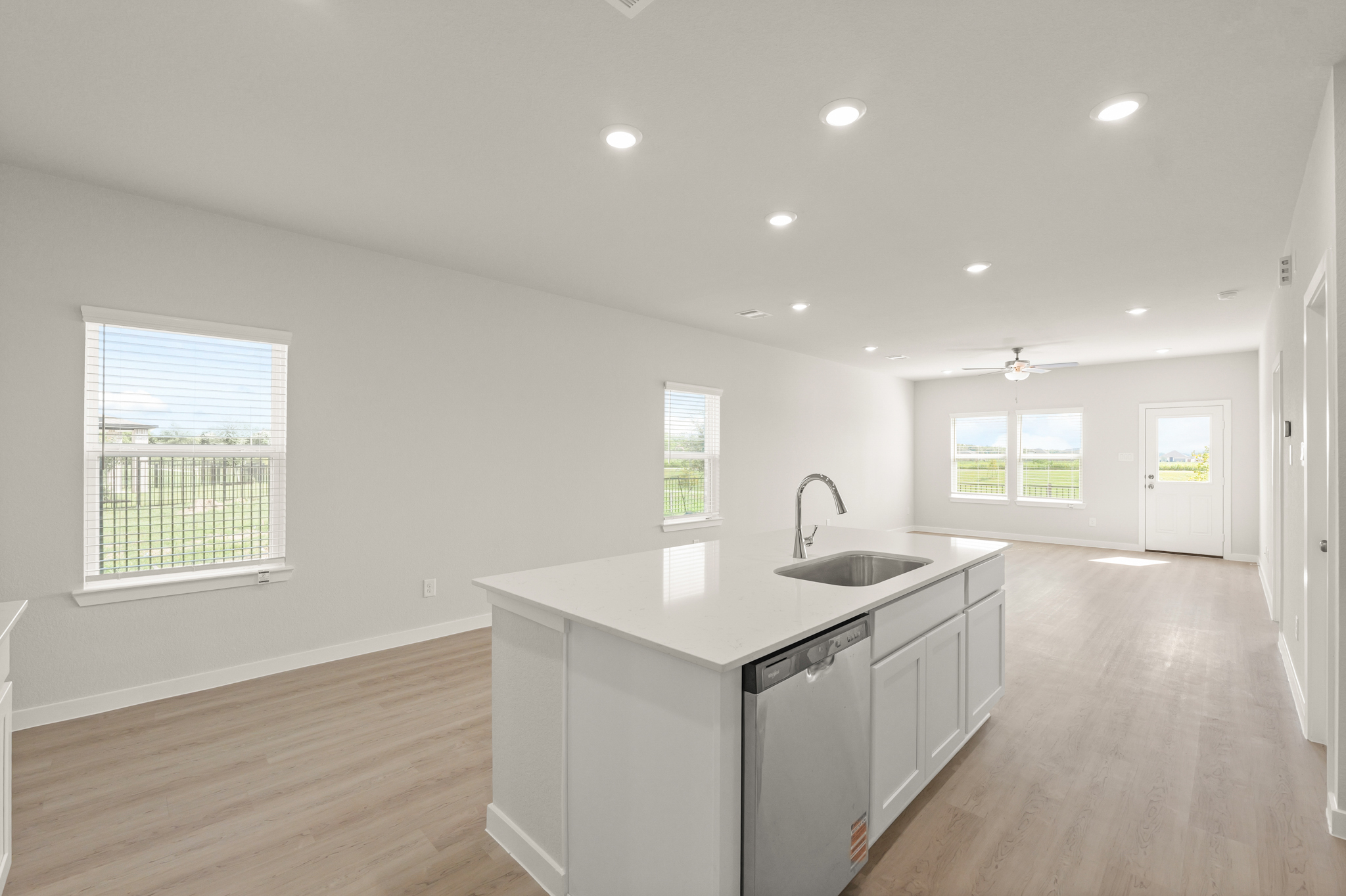 A kitchen with white cabinets.