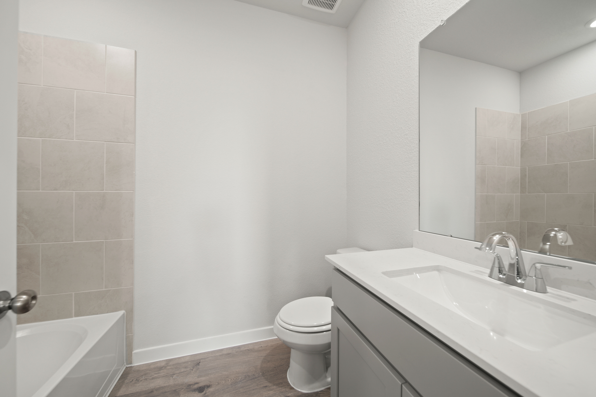 A bathroom with a tub sink and toilet.