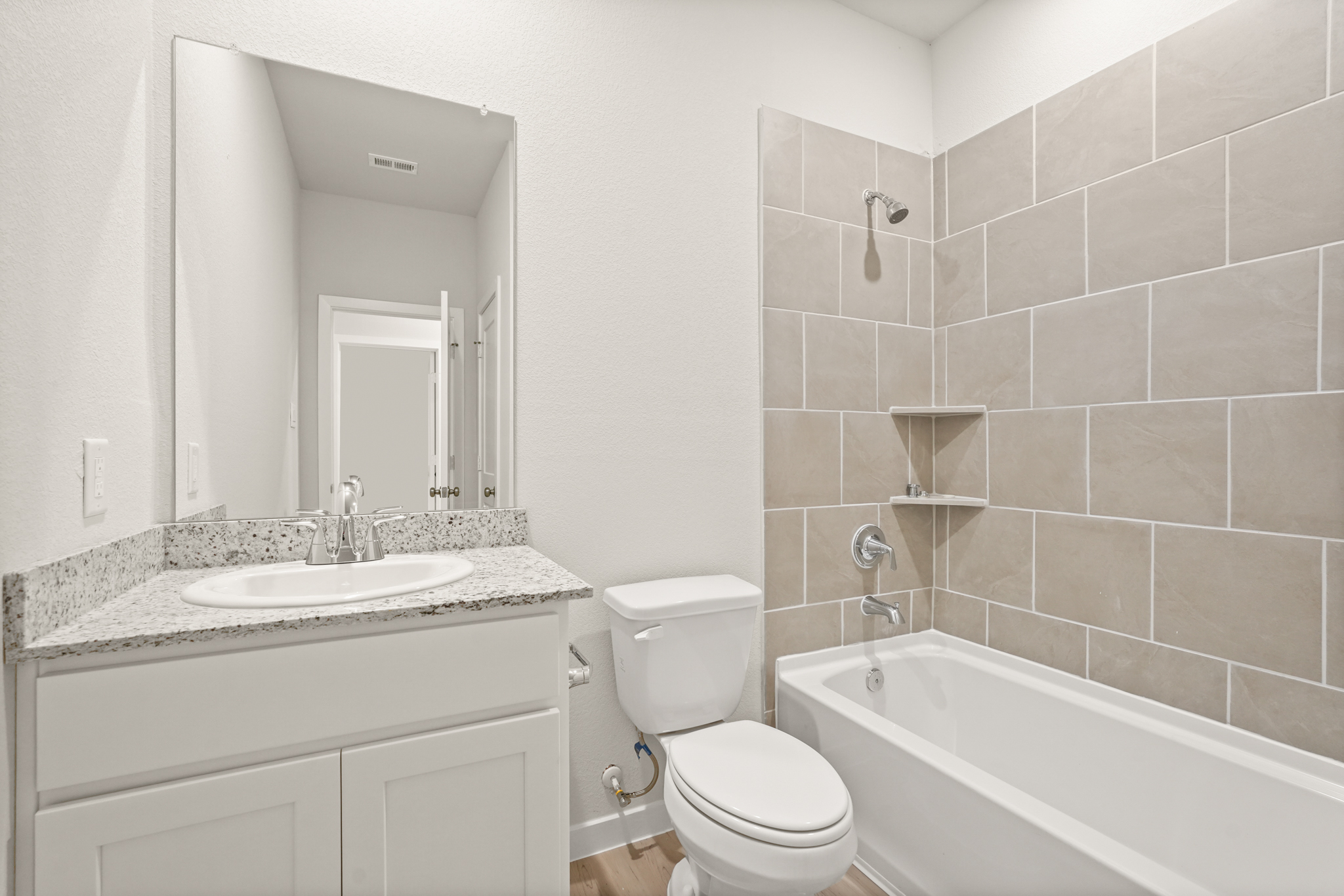 A bathroom with a sink toilet and bathtub.