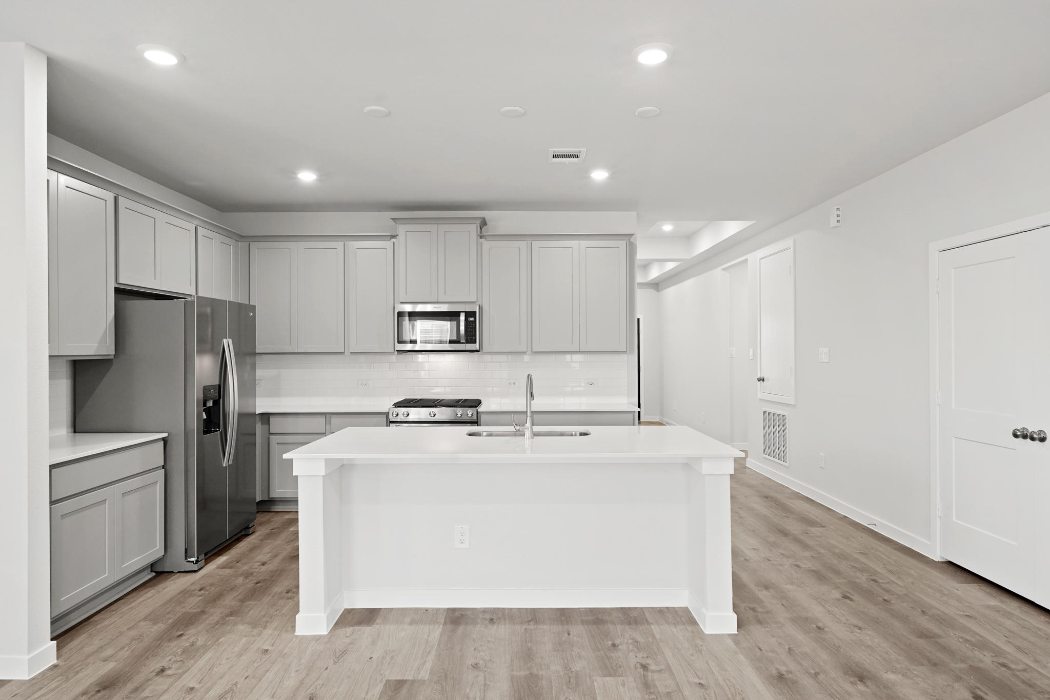 A kitchen with white cabinets.