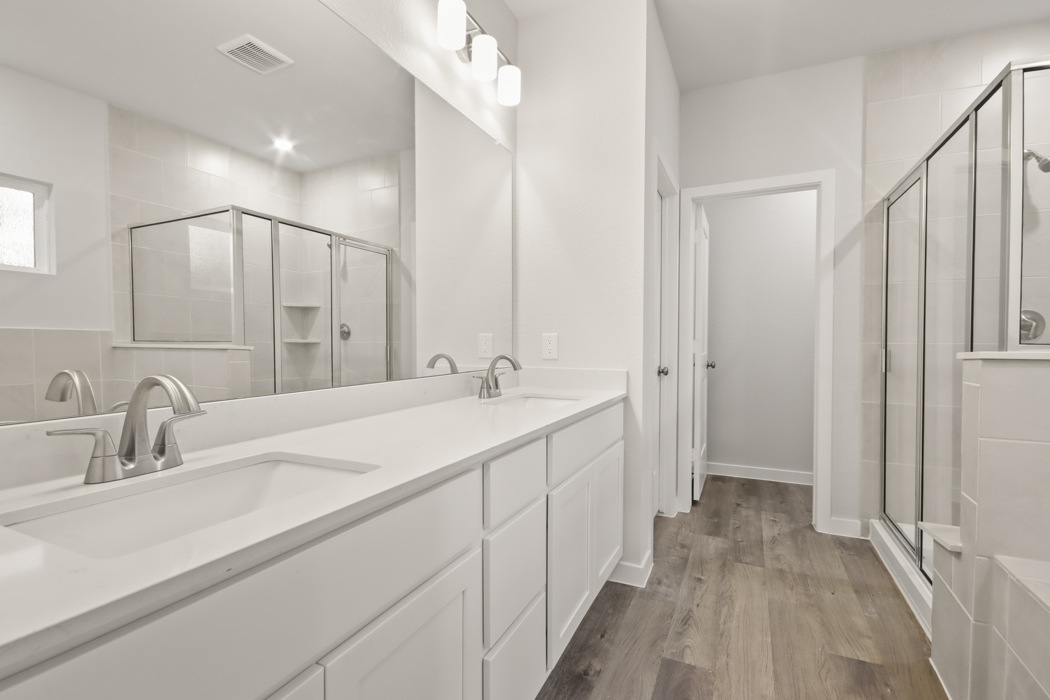 A bathroom with a large mirror.