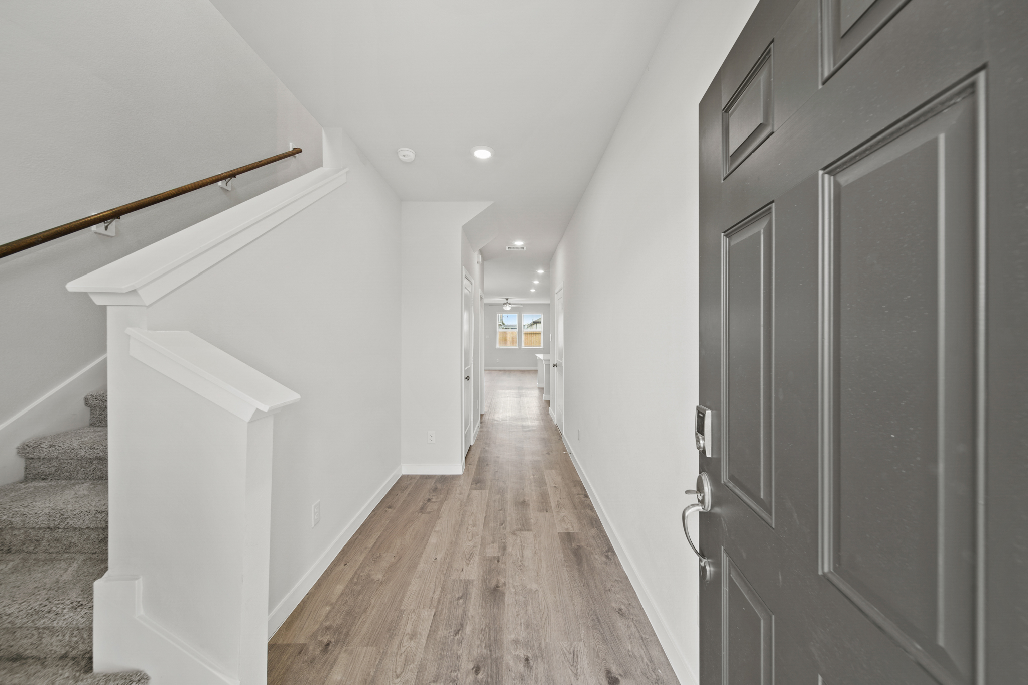 A hallway with white walls.