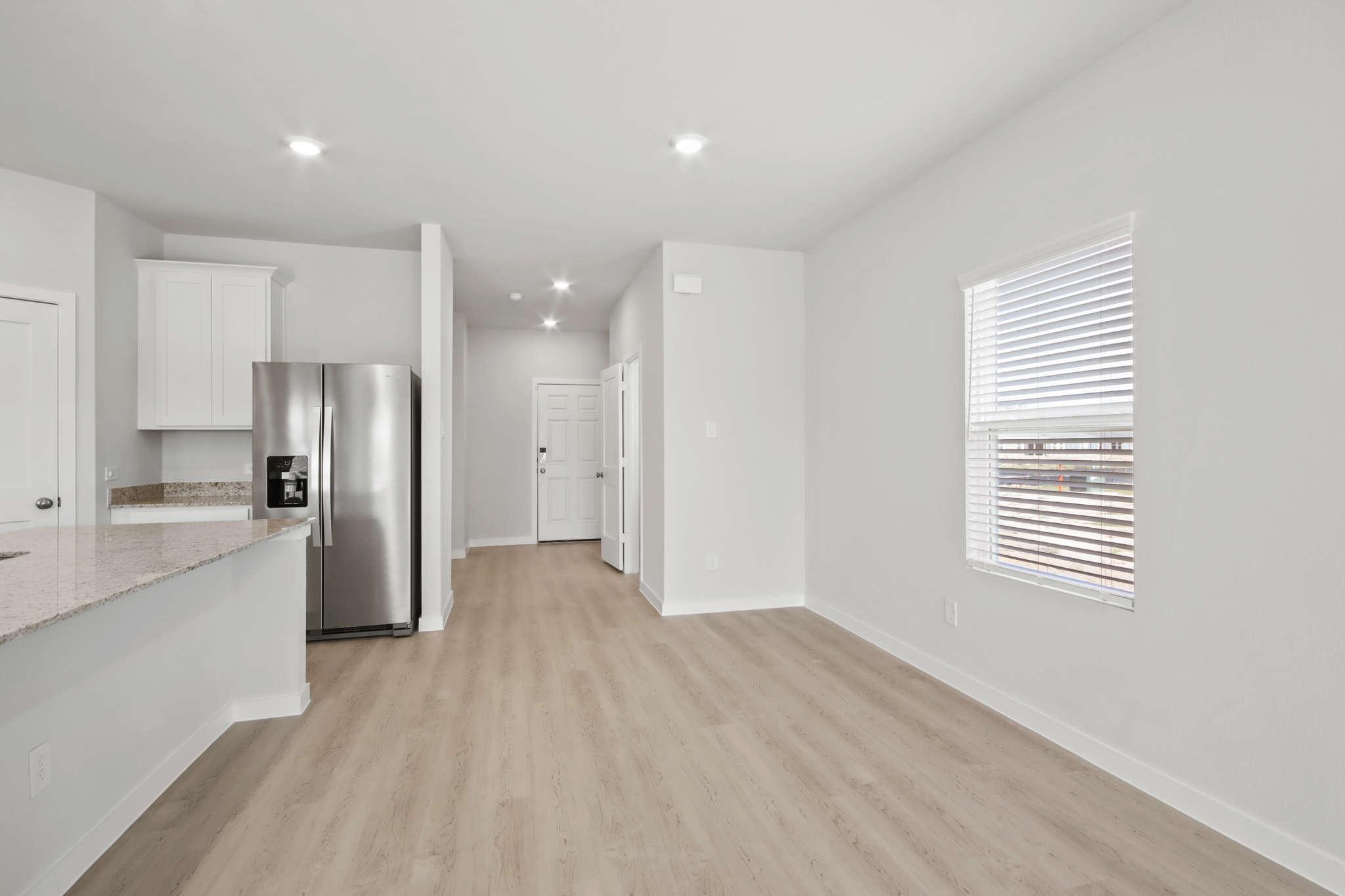 A kitchen with white cabinets.
