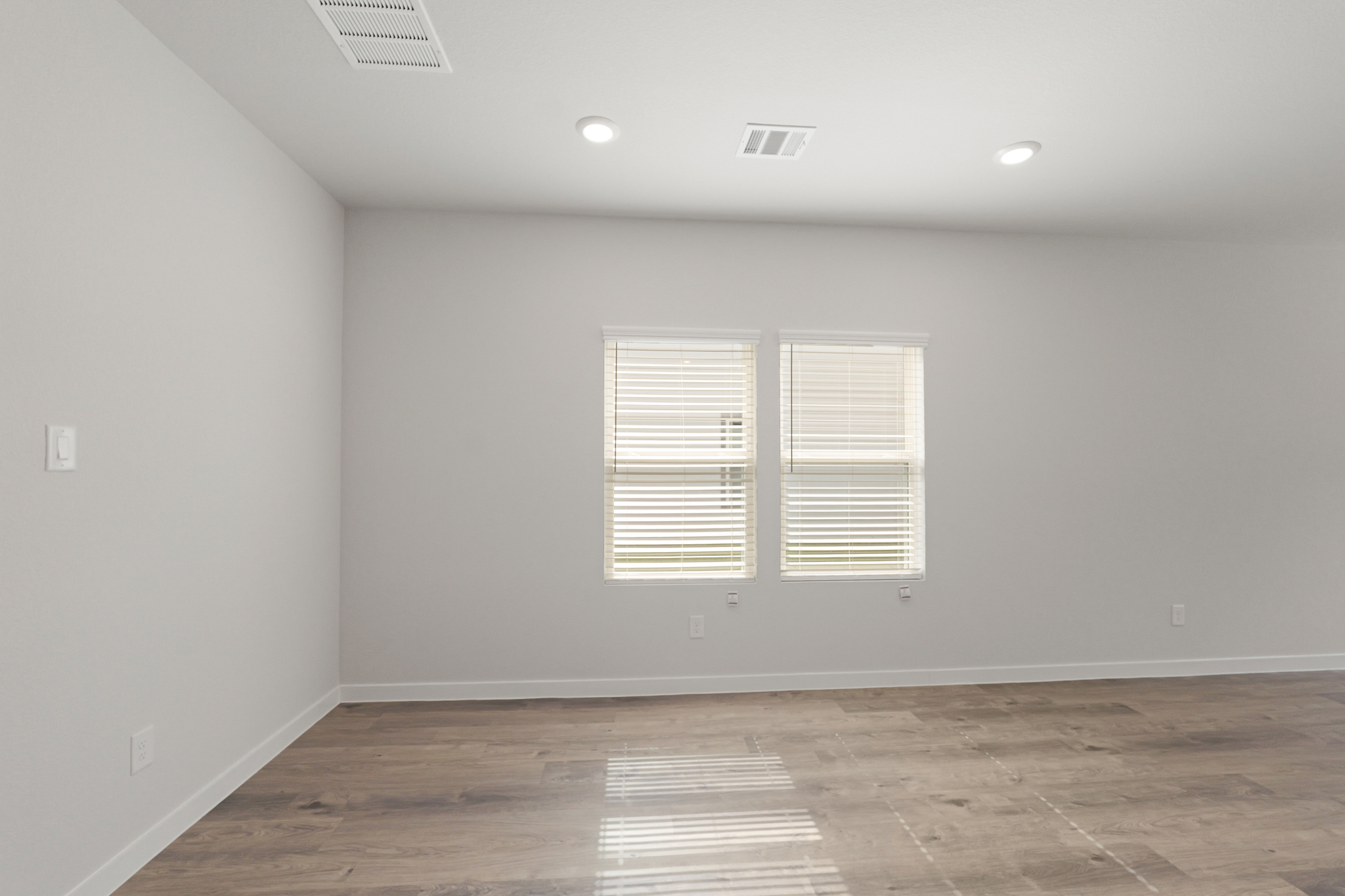 A room with white walls and windows.