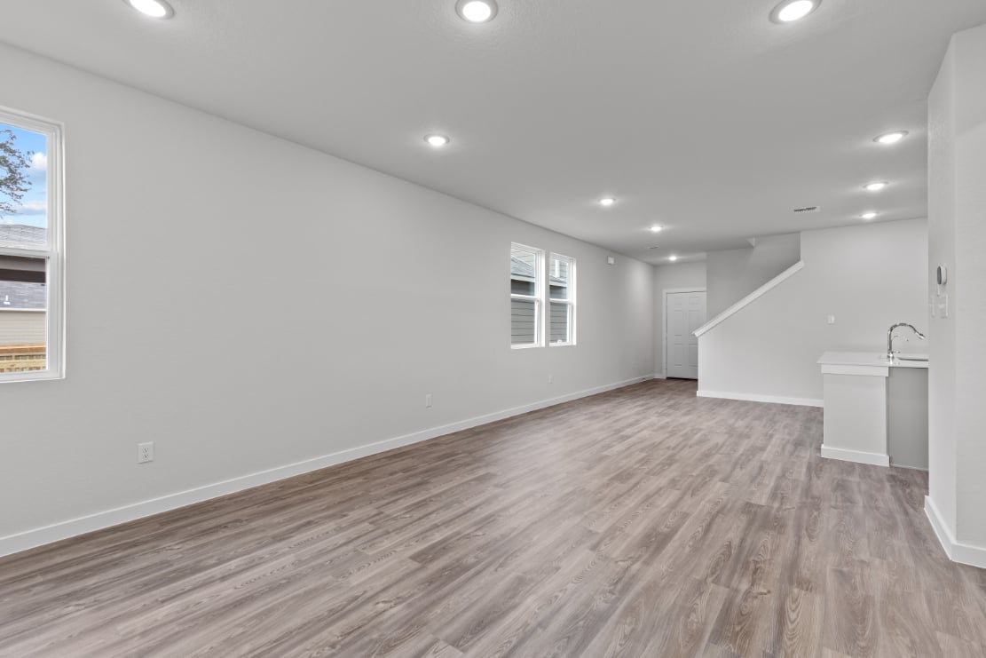A room with a wood floor and a sink.