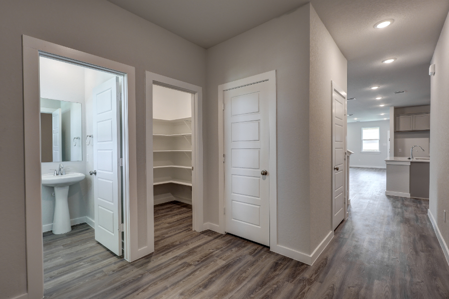 A bathroom with white cabinets.